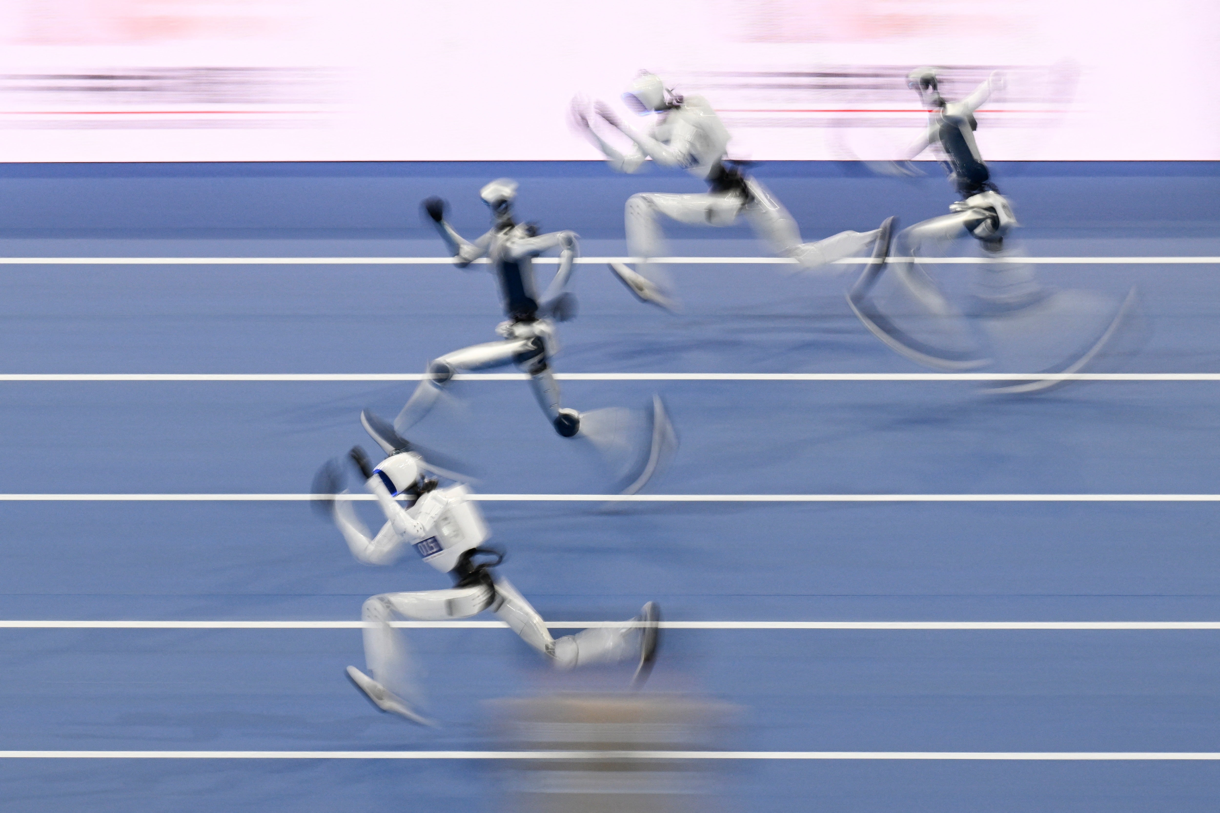 Humanoid robots compete in the 100-meter race during the 2nd World Humanoid Robot Games in Beijing on August 25, 2026