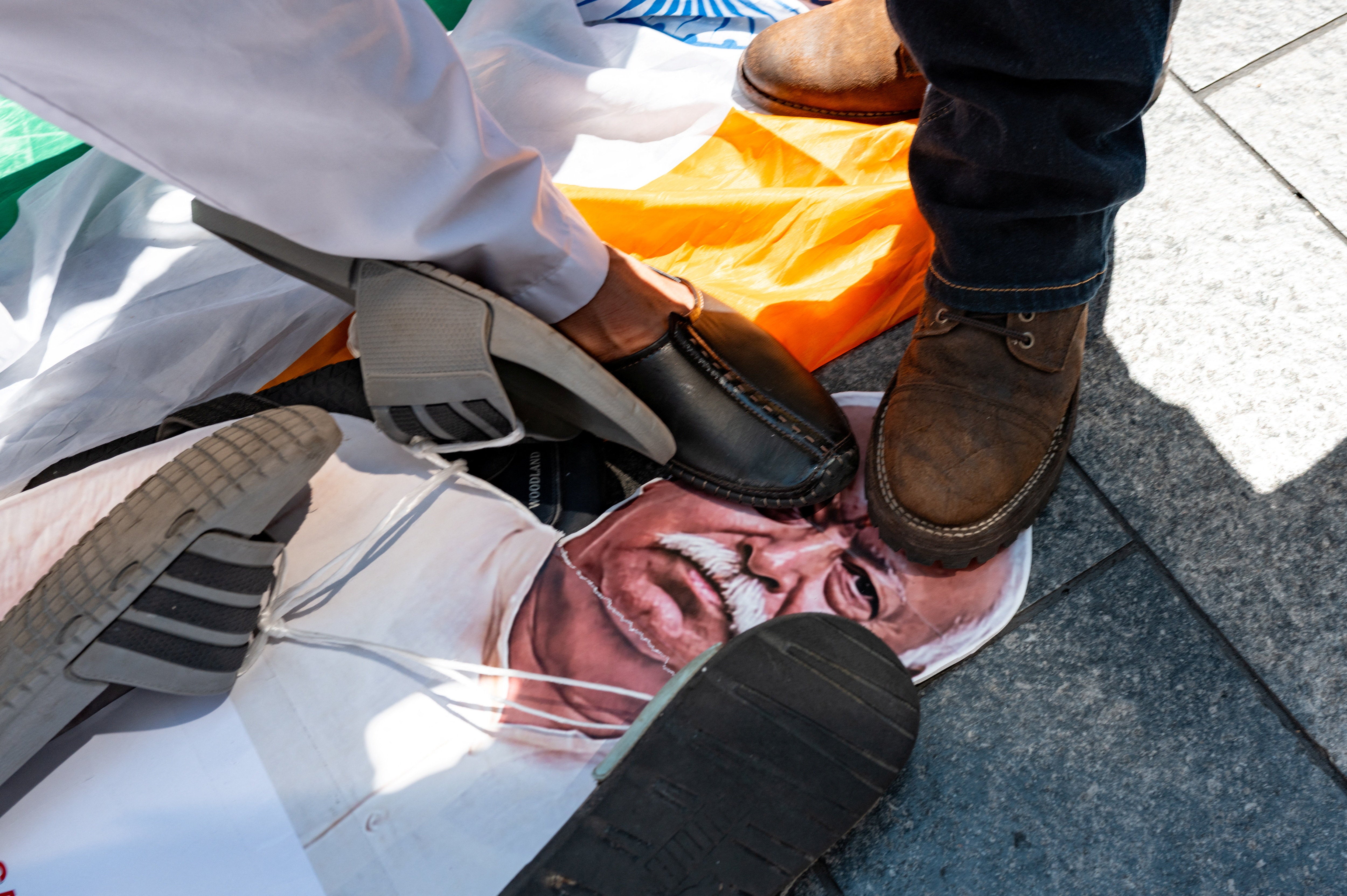 People stomp on a a cardboard cutout of Mohan Bhagwat during a protest against the RSS in New York City on 29 August 2026 (Reuters)