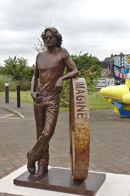 The almost 6ft-tall sculpture is cast in bronze with a green patina, mounted on a substantial bronze and steel base, and is visited by tens of thousands of Beatles fans each year (Wikimedia Commons)