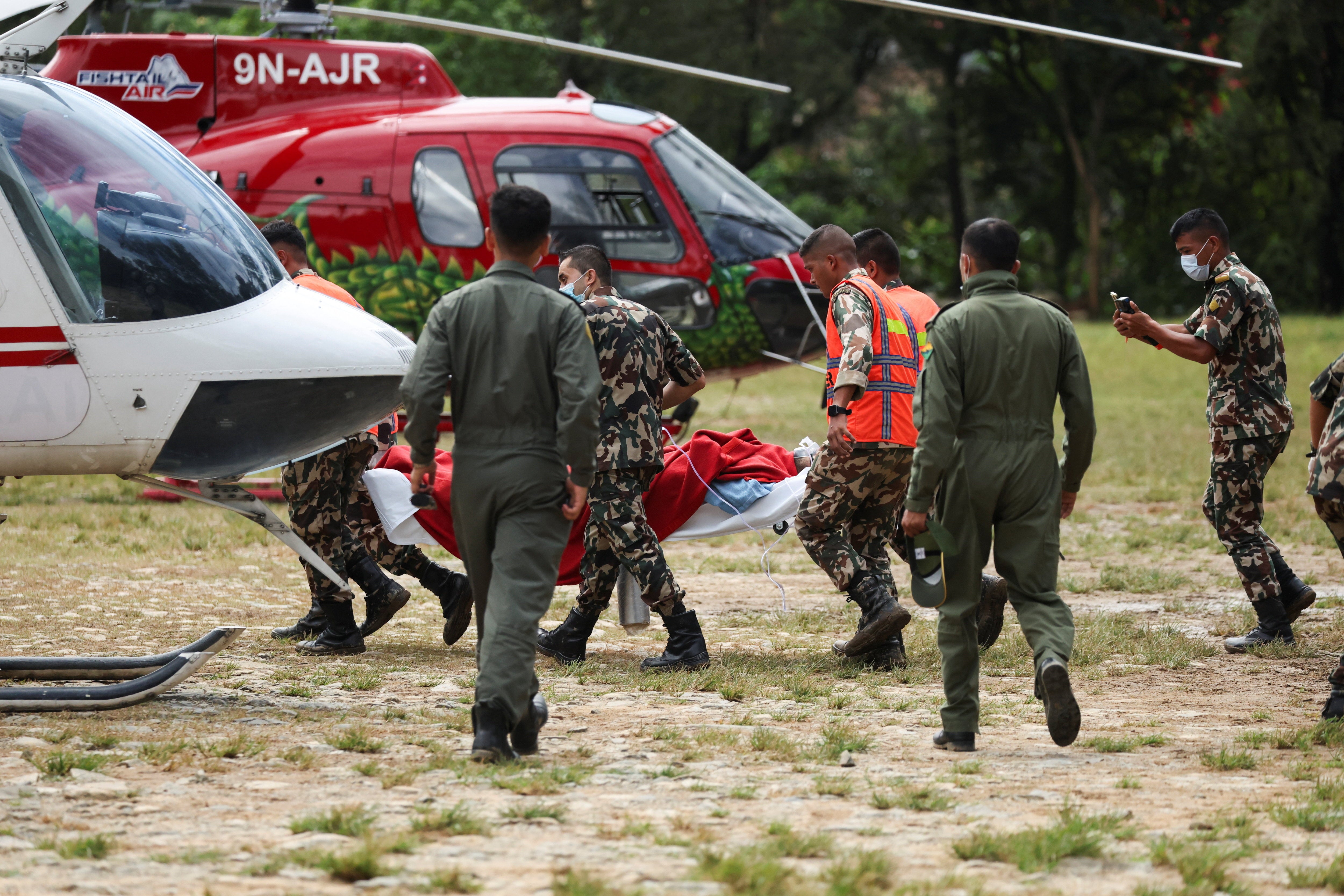 Anil shah, a survivor rescued from a tunnel of the Upper Trishuli 3A hydropower project nine days after the deadly flash floods and a mudslide, is carried to be air lifted to Kathmandu from an army base in Nuwakot, Nepal, September 4, 2026