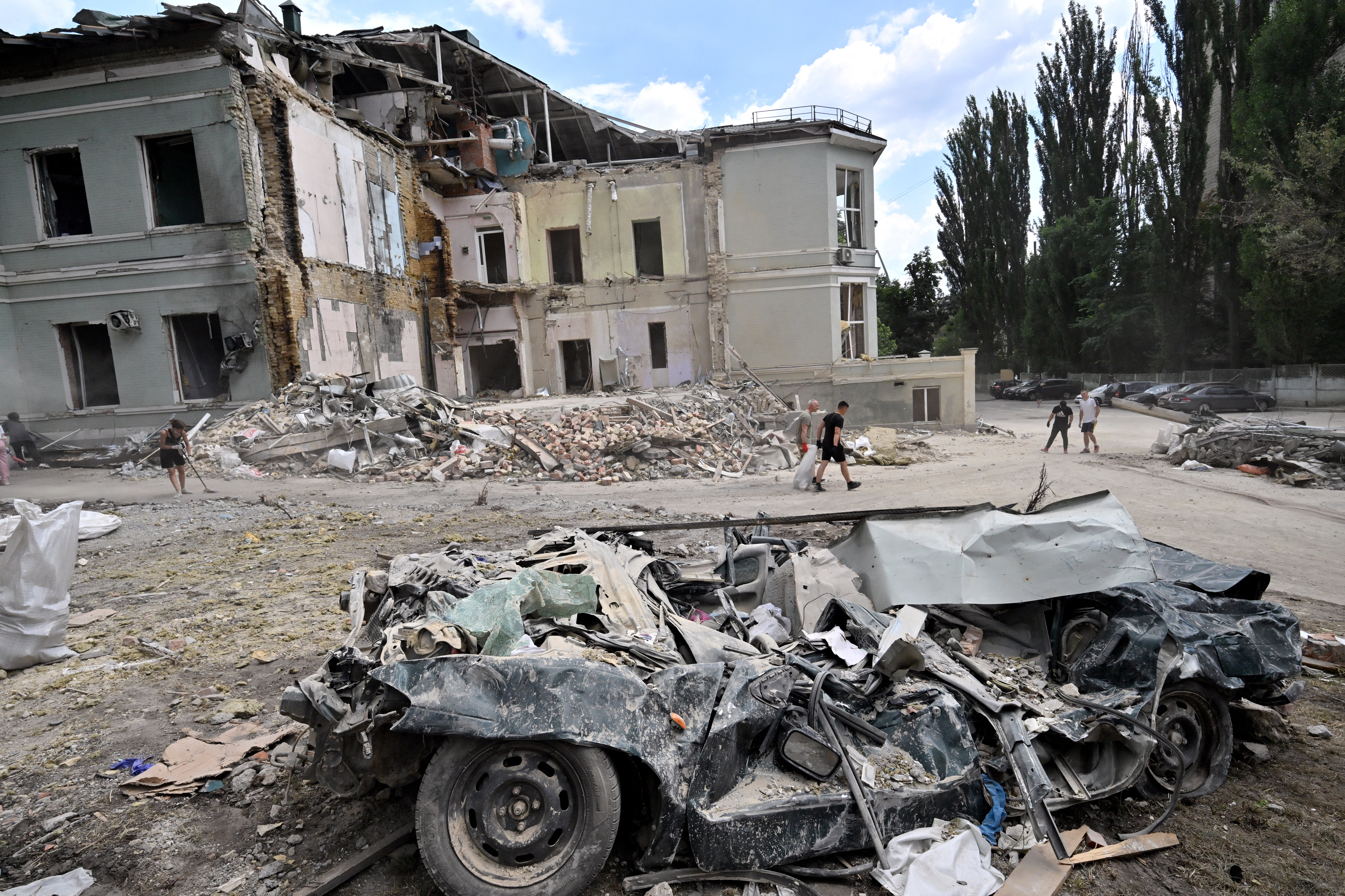 Volunteers carry a sack with debris in Okhmatdyt, the biggest children's hospital in Ukraine, in Kyiv, on 12 July 2024 (AFP/Getty)