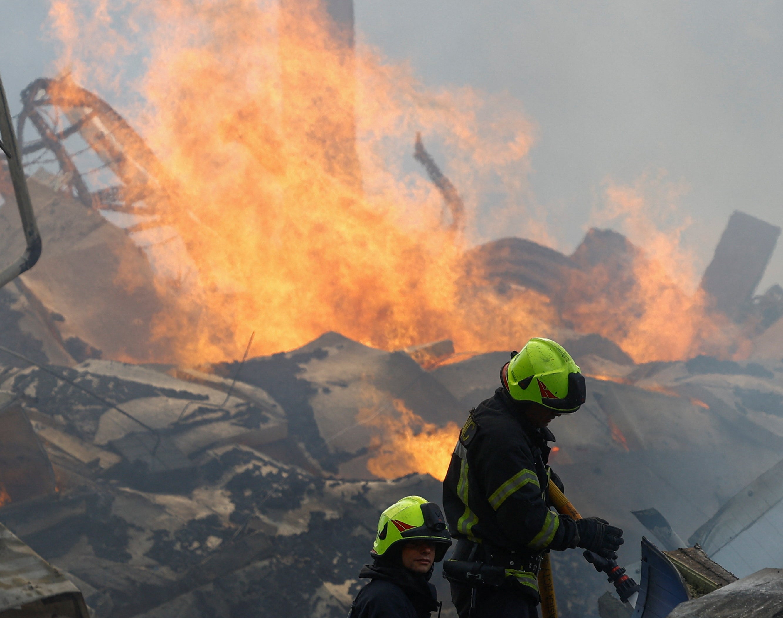 Firefighters work at the site of a warehouse hit by a Russian drone strike in the town of Brovary, amid Russia's attack on Ukraine, in Kyiv (Reuters)