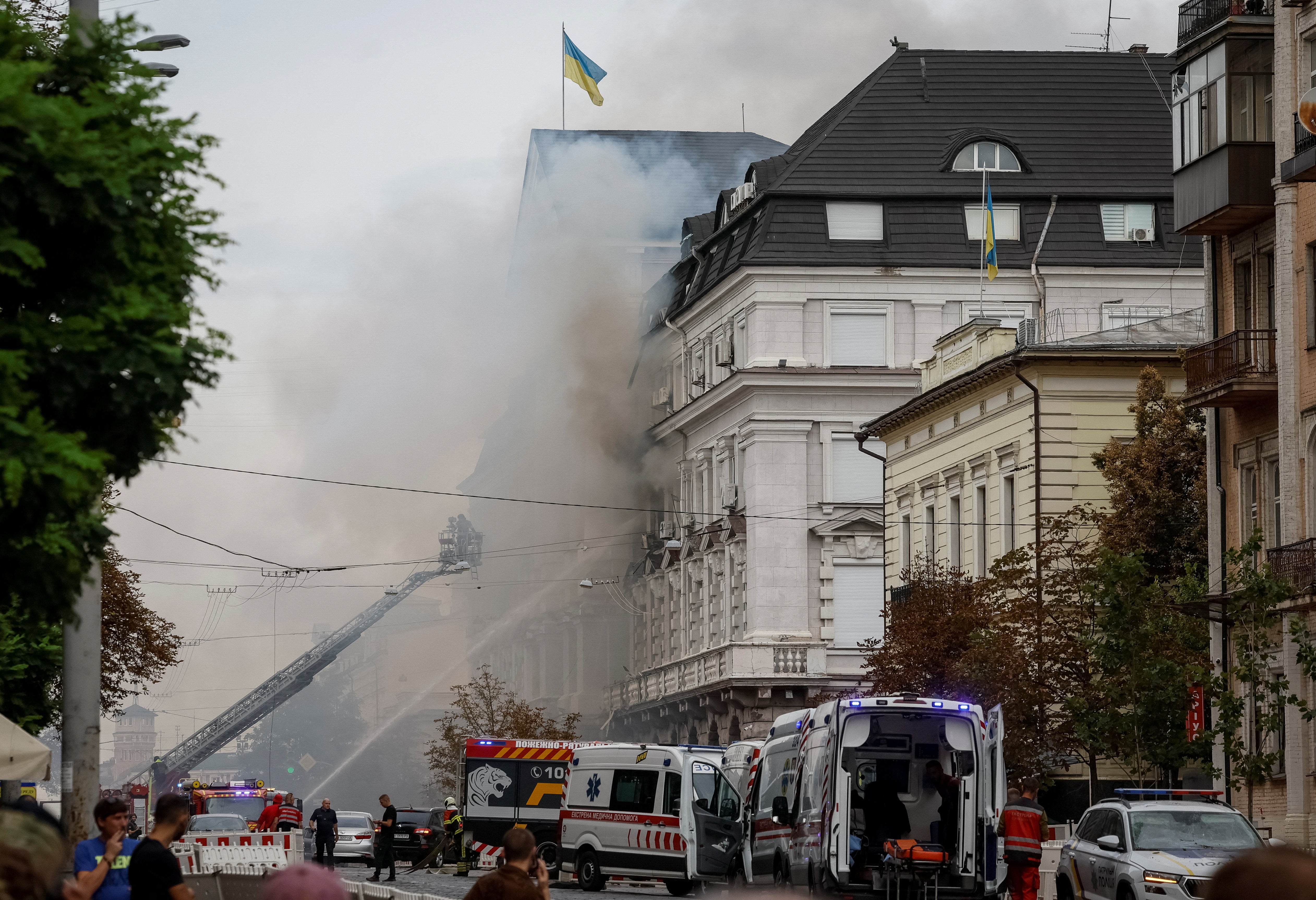 Firefighters work at a site of a building of the headquarters of Ukraine's SBU security service after a Russian drone strike