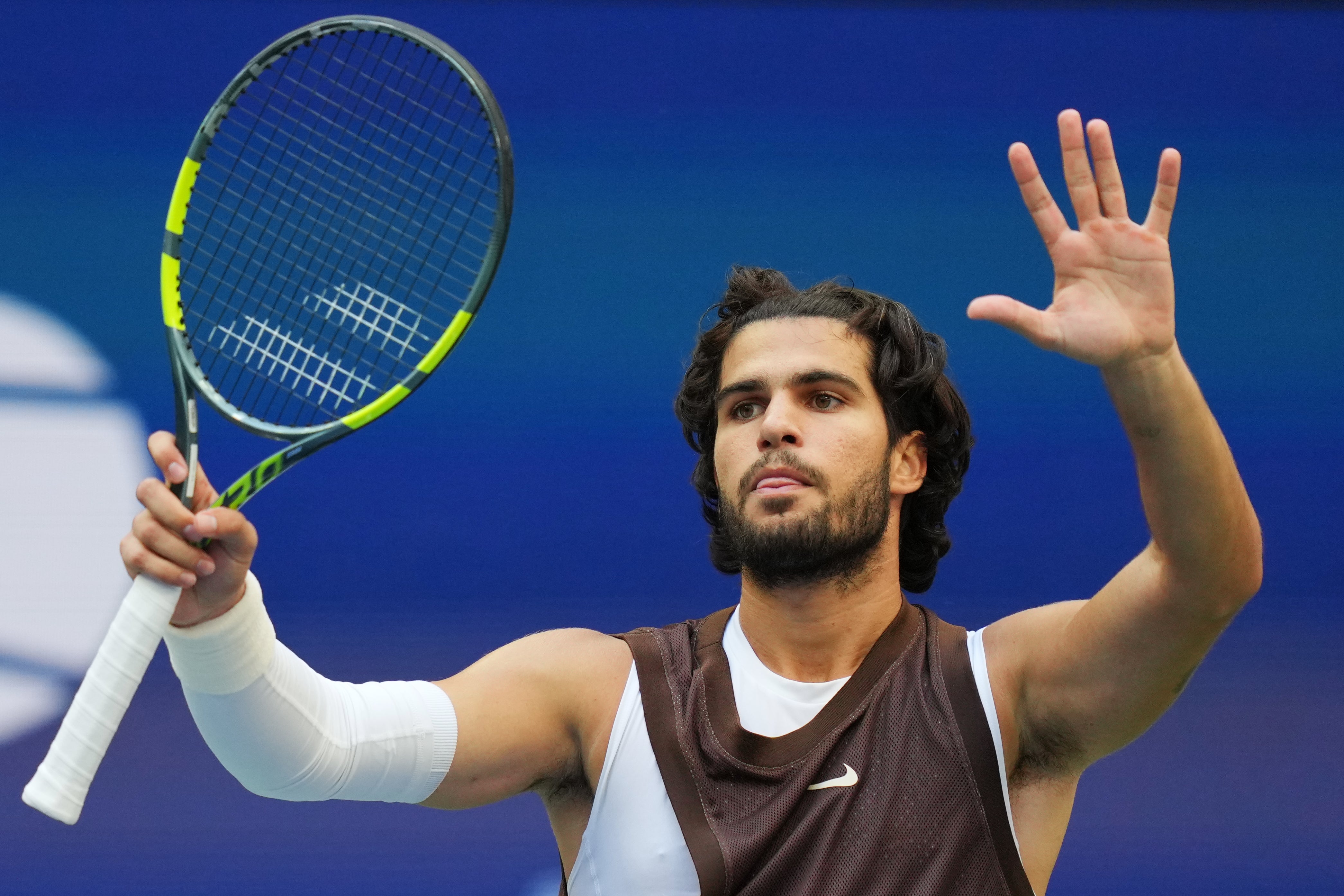 Alcaraz wore a vest to cover his modesty at Flushing Meadows (Kirsty Wigglesworth/AP)