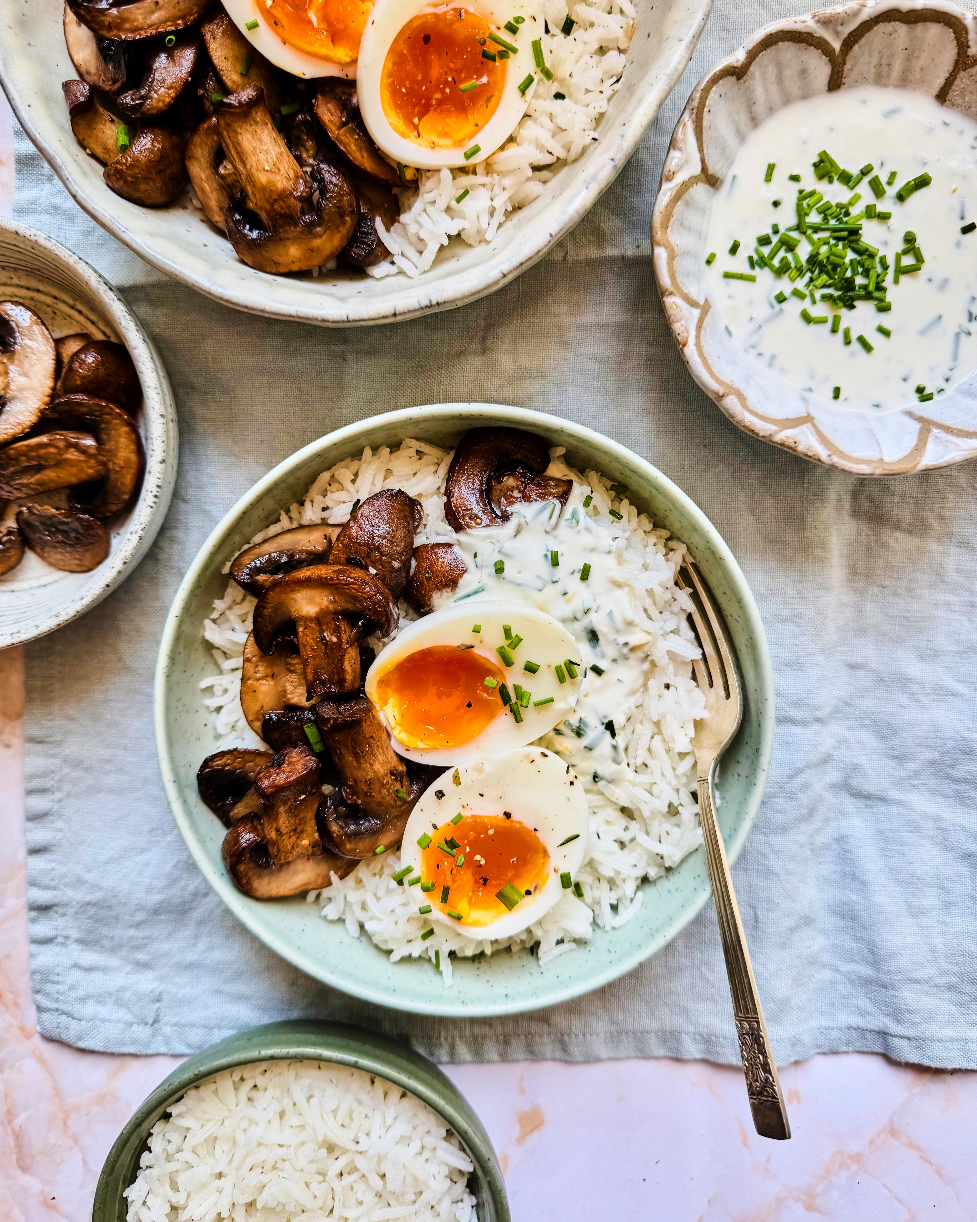 Basmati rice topped with golden mushrooms, jammy eggs and herby yoghurt