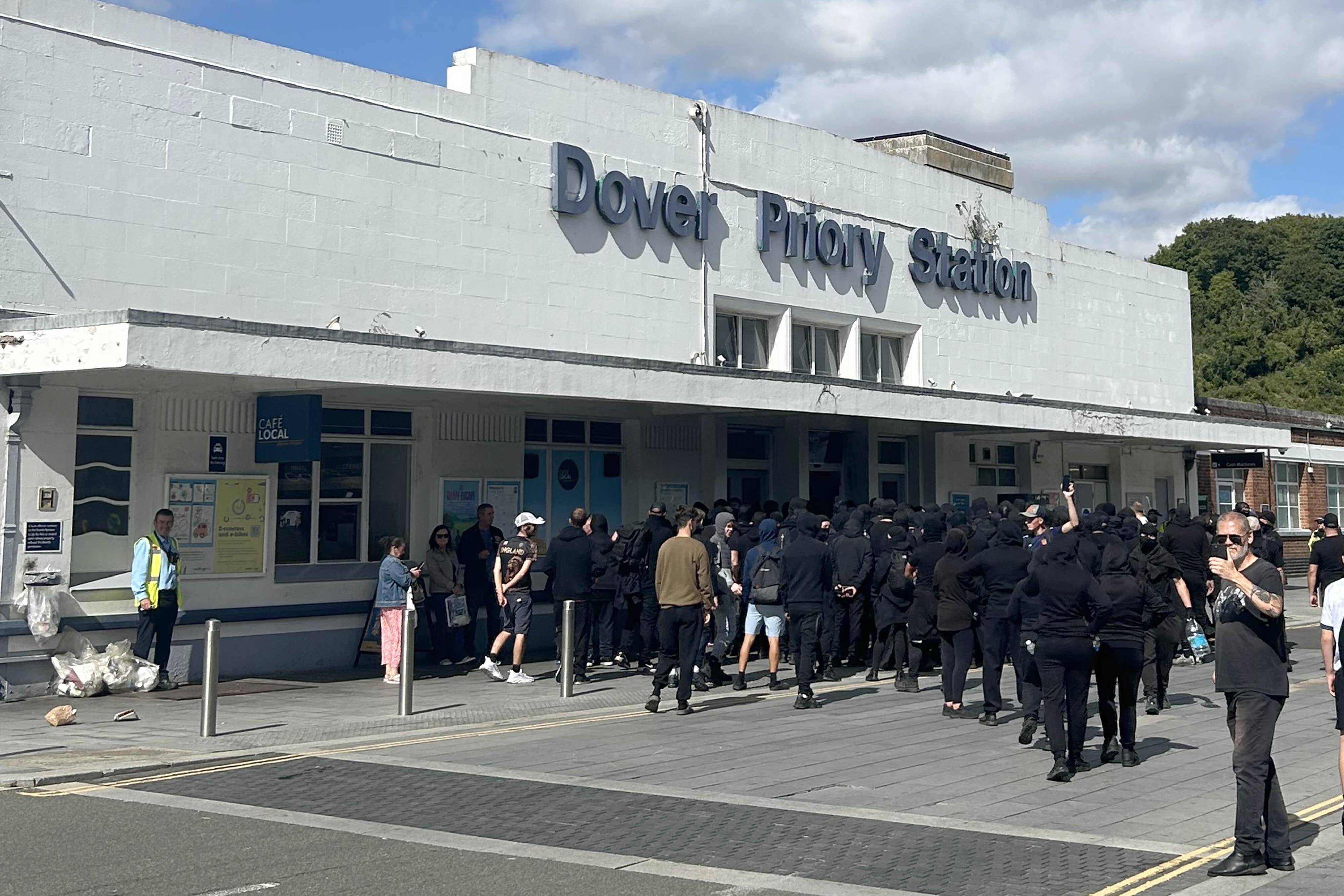 Protesters at Dover Priory train station after black-clad and masked anti-illegal migrant demonstrators blocked roads in the port (Oscar Rihill/PA) (PA Wire)
