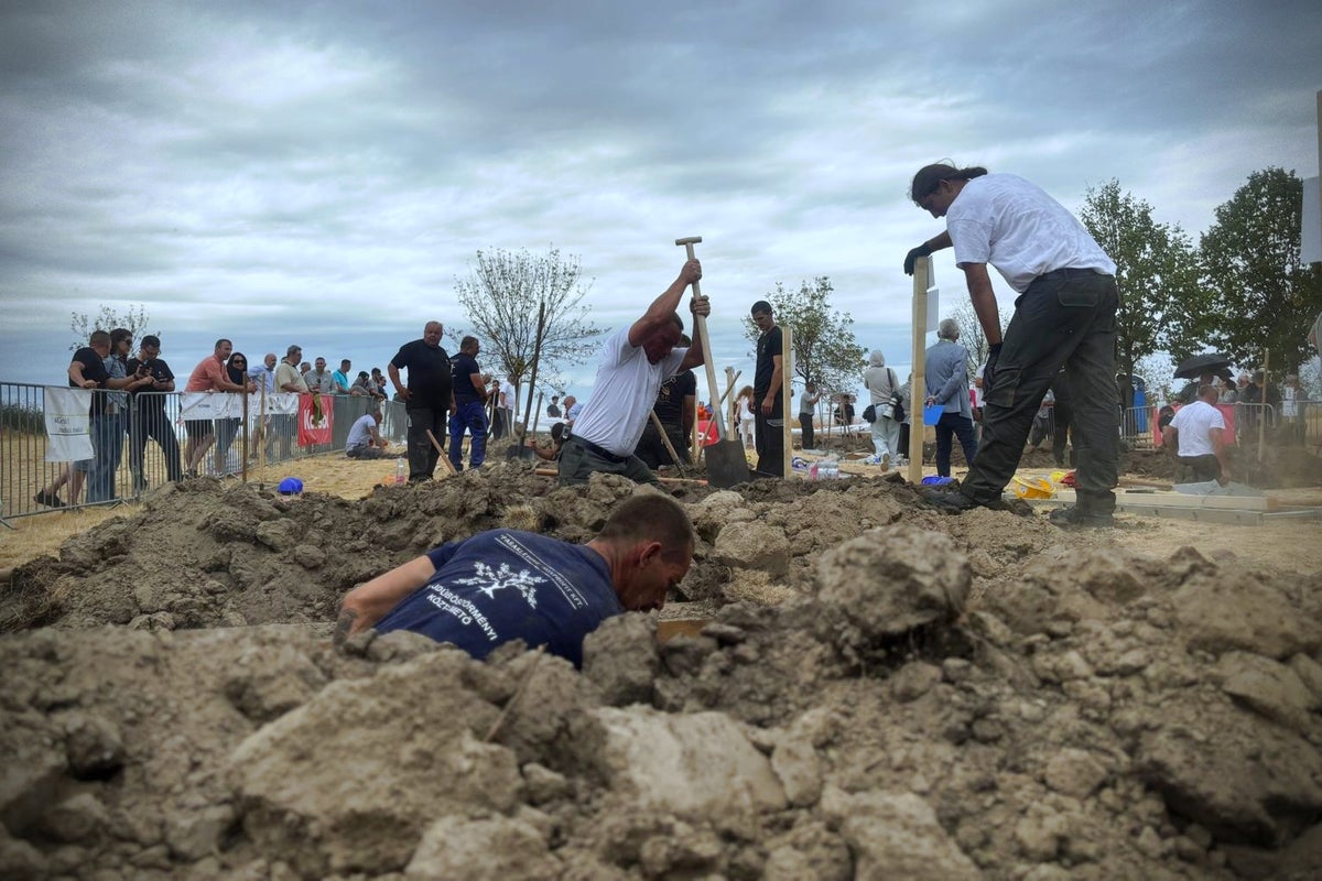 Competitors take part in Hungarian grave-digging contest in cemetery