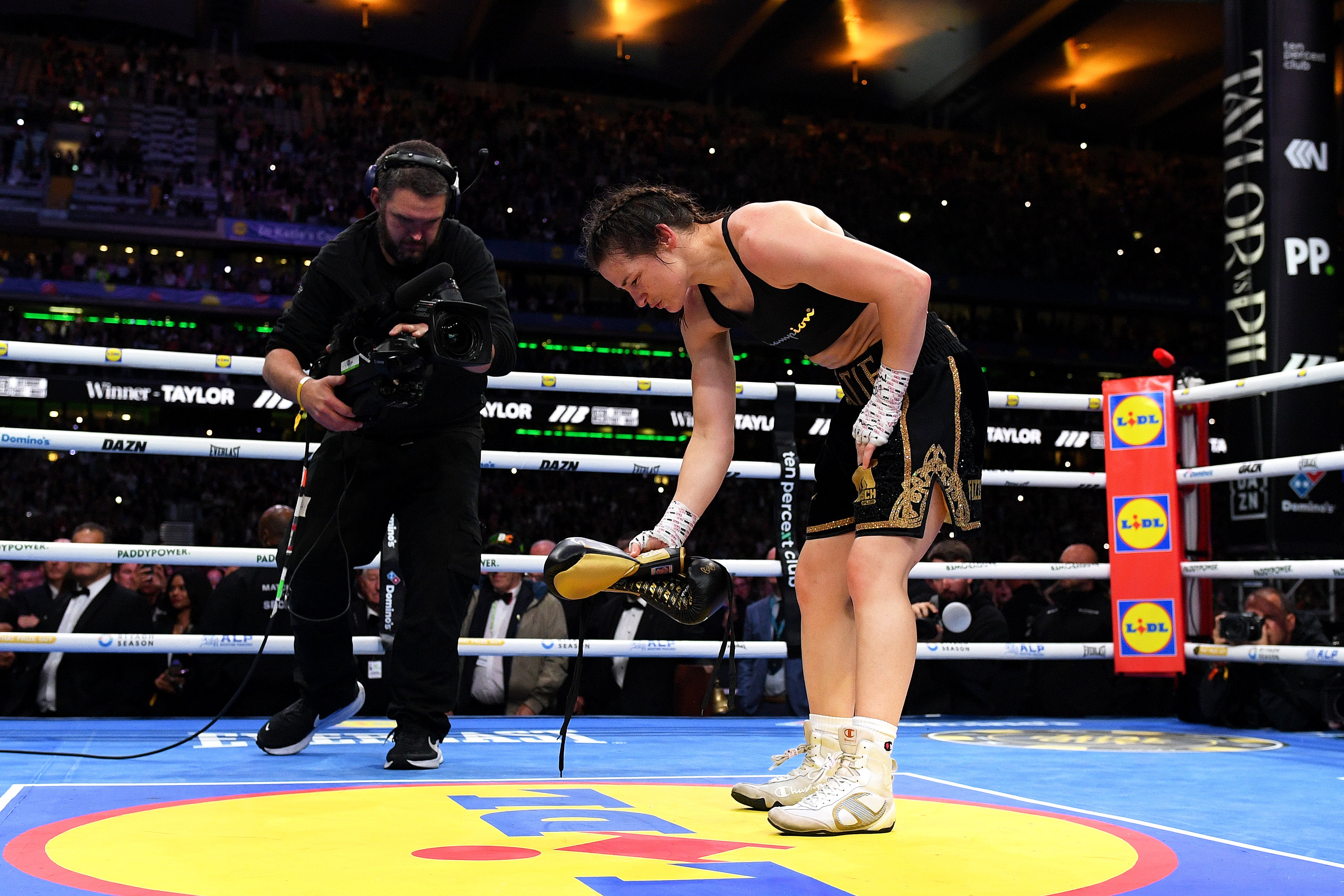 Katie Taylor leaving her gloves in the ring after one final victory
