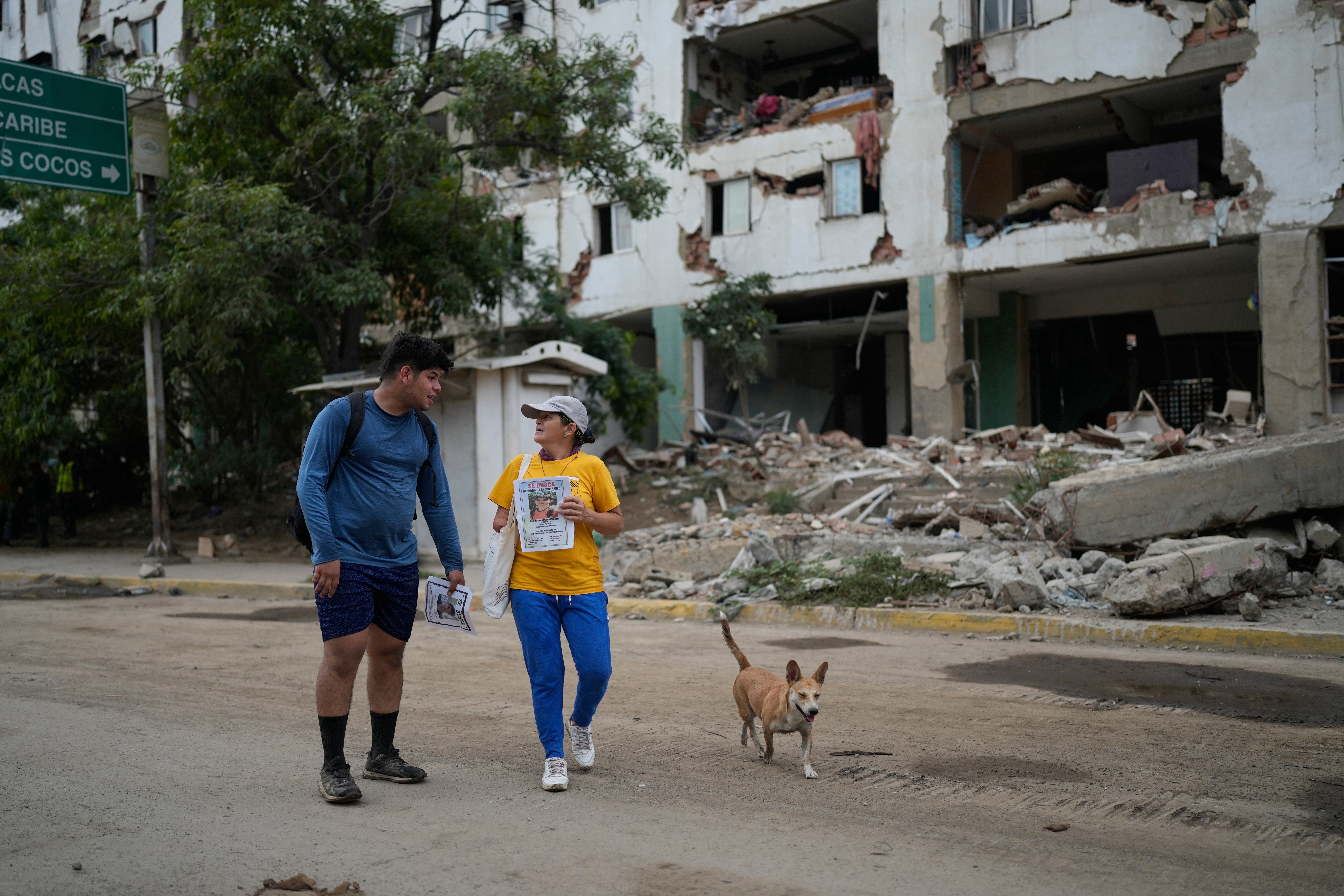 Pedro Gomez, left, walks through La Guaira, Venezuela, with a friend