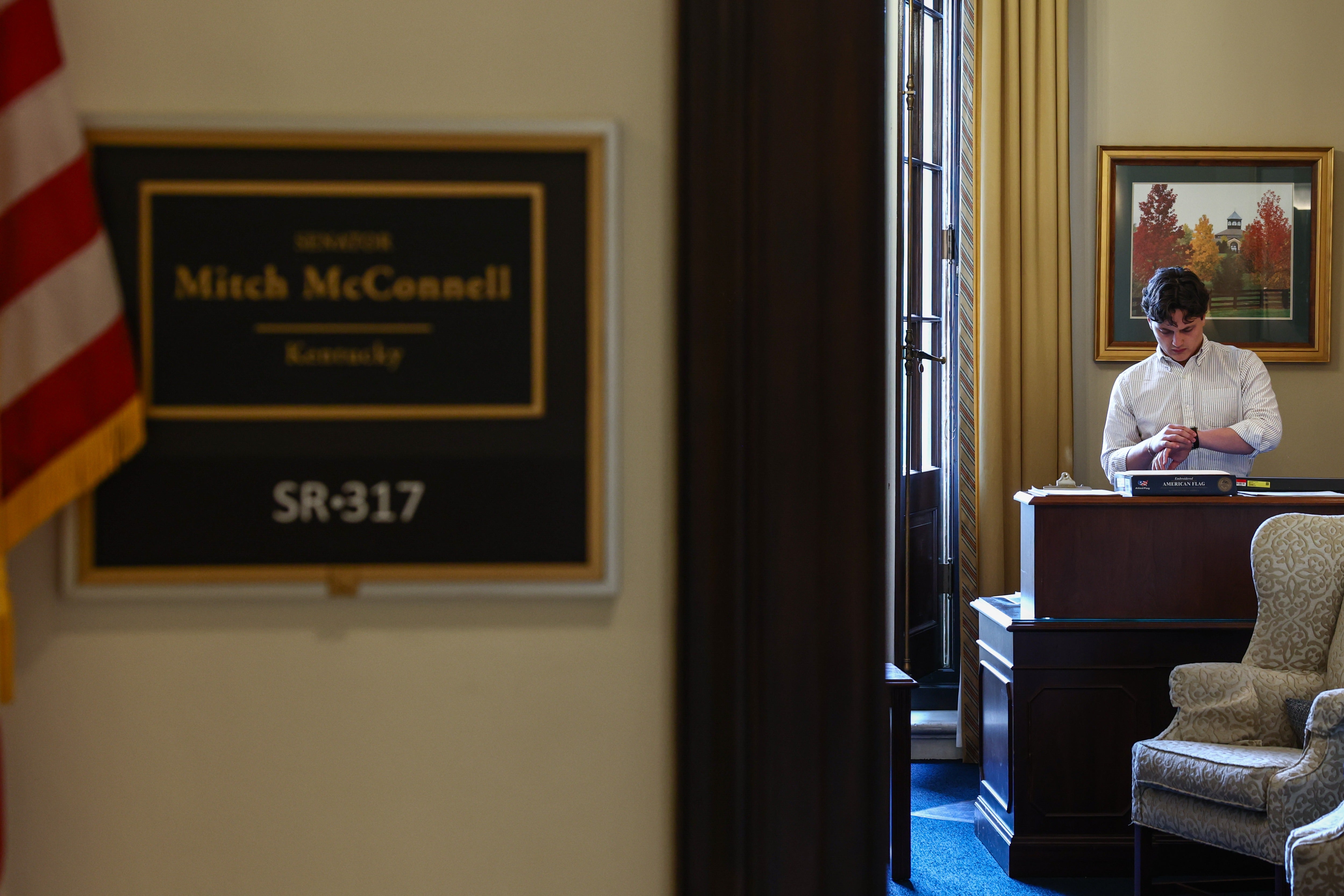 A staff member checks his watch inside of McConnell's office in Russell Senate Office Building on July 8 as the senator remained out of work (Getty Images)