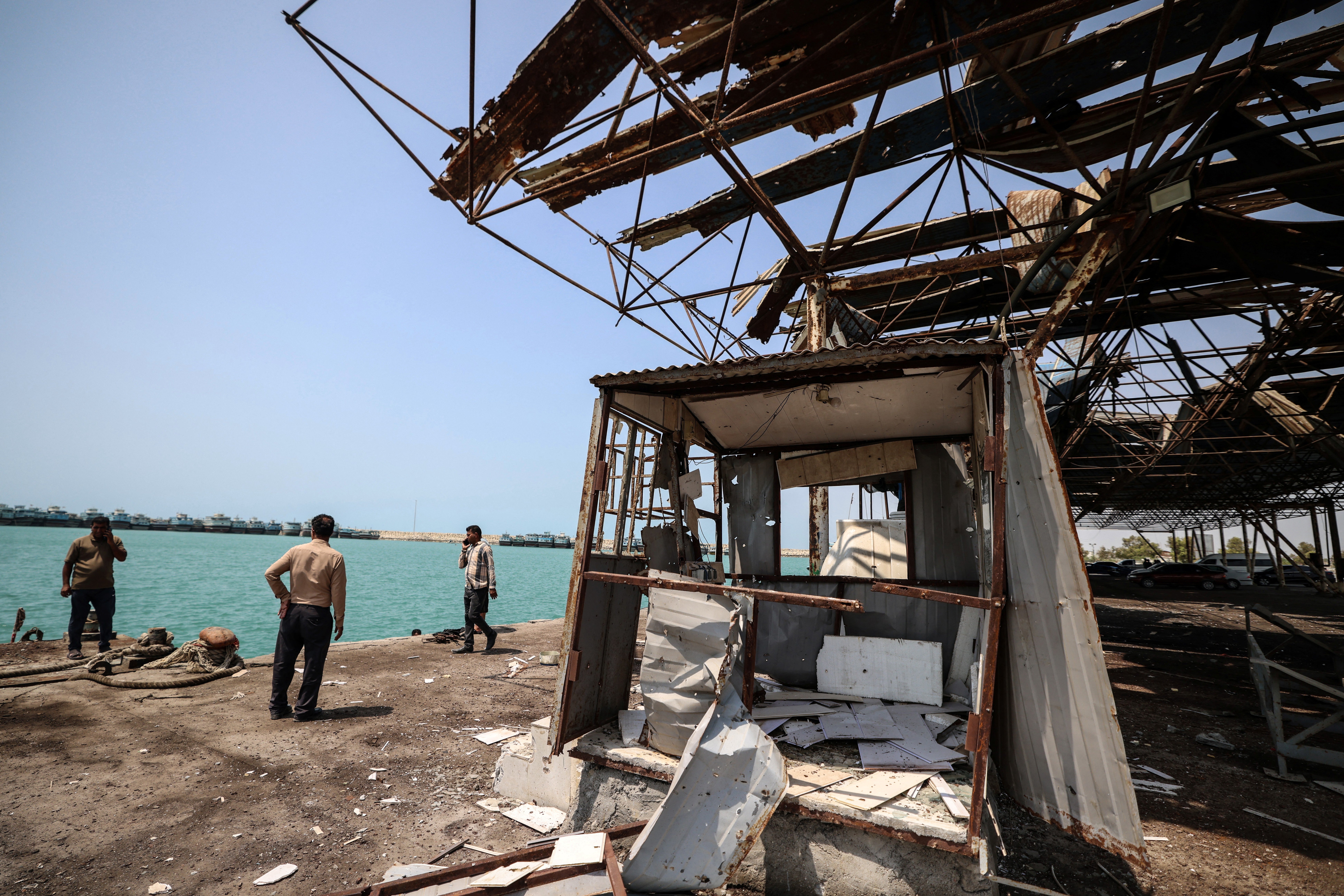 Iranians gathered at the damage to the storage and warehousing facilities