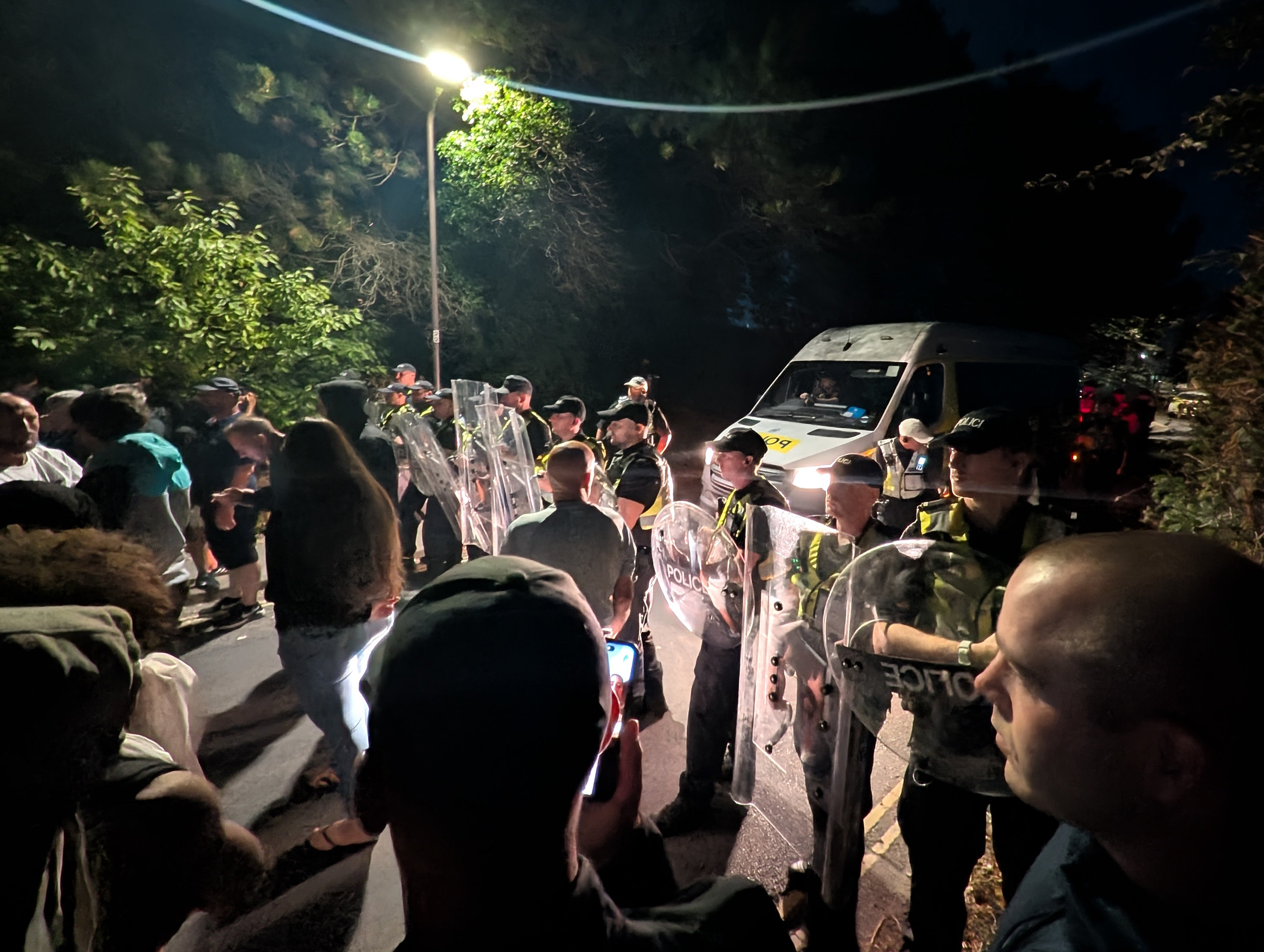 Police officers at the scene where hundreds of protesters gathered, after a small boat thought to be containing asylum seekers was heading towards the coast (PA Wire/PA Images) (PA Wire)