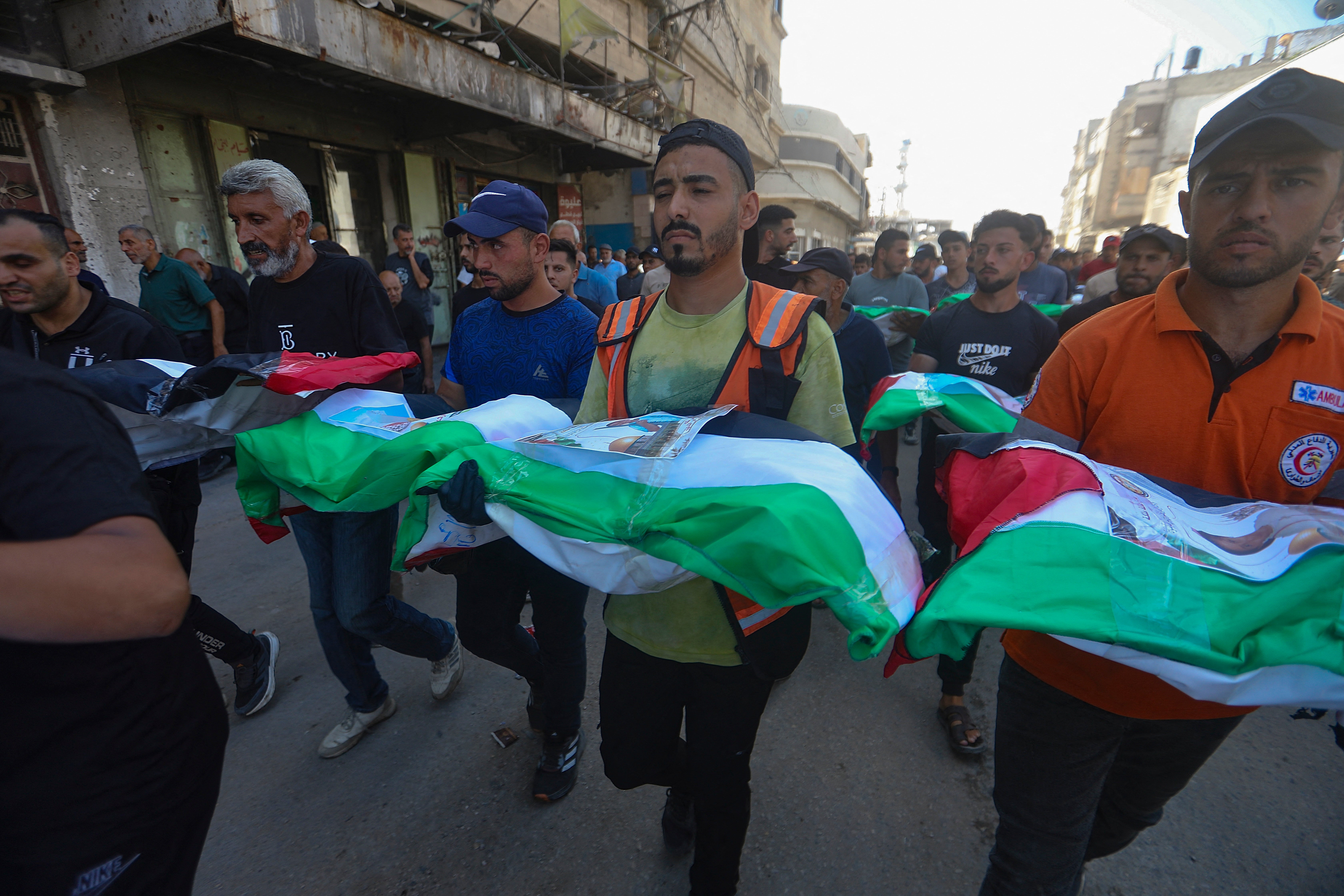 People carry the remains of victims wrapped in Palestinian flags during a funeral procession in Zeitoun neighborhood of Gaza City, Gaza (AFP/Getty)