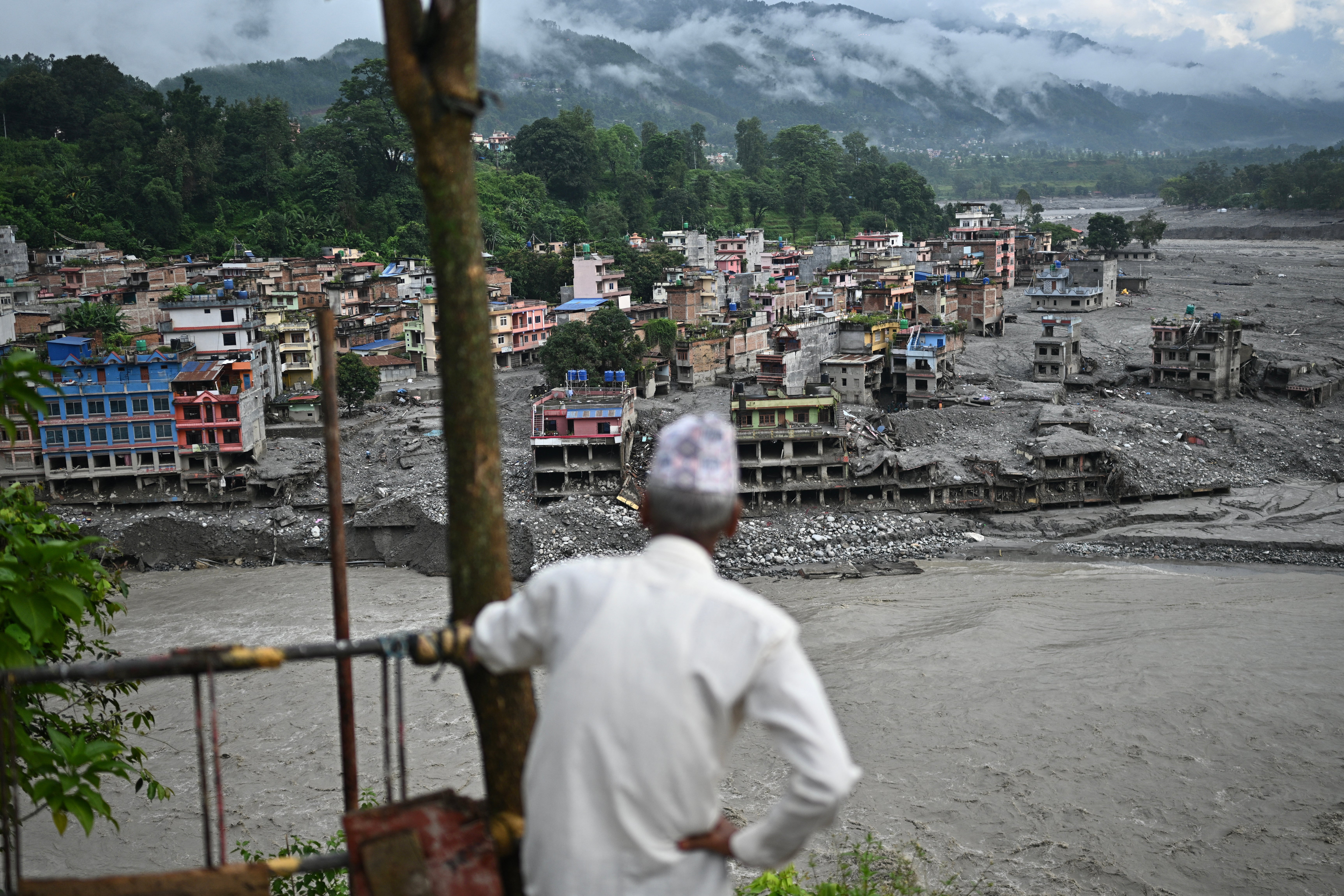 A man looks at the remains in the aftermath of flash floods at Trishuli in Nepal's Nuwakot district on 7 September 2026. - The 26 August glacial and mountain collapse on the China-Nepal border killed at least 1,398 people, with more than 5,500 missing, including around 800 foreigners