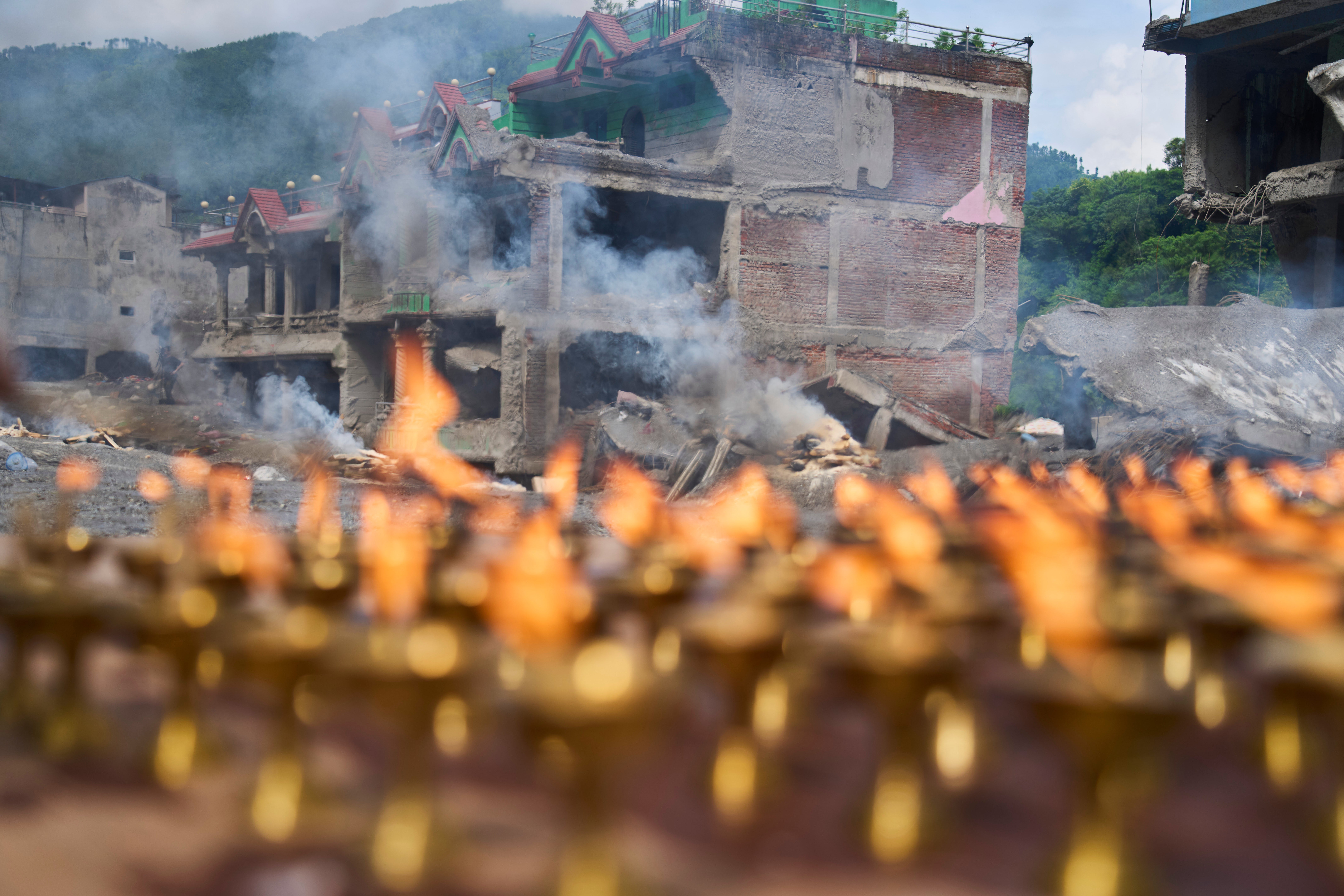 Lamps burn as Buddhist monks perform rituals and prayers for victims of the recent flash floods in the Dhunge area of Nuwakot district, Nepal, Monday, 7 September 2026