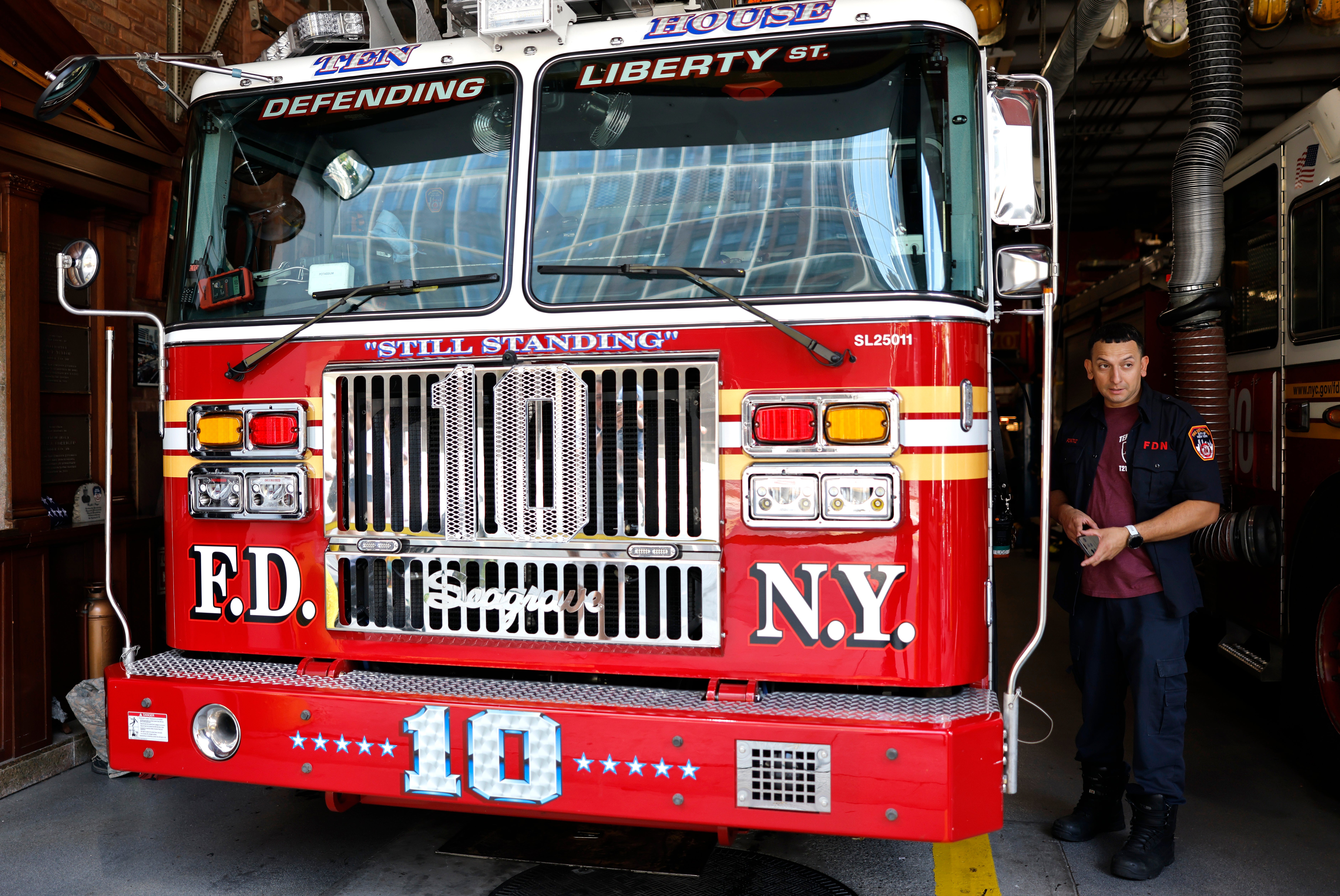 A firefighter works in the rebuilt FDNY Ten House adjacent to the World Trade Center on August 23