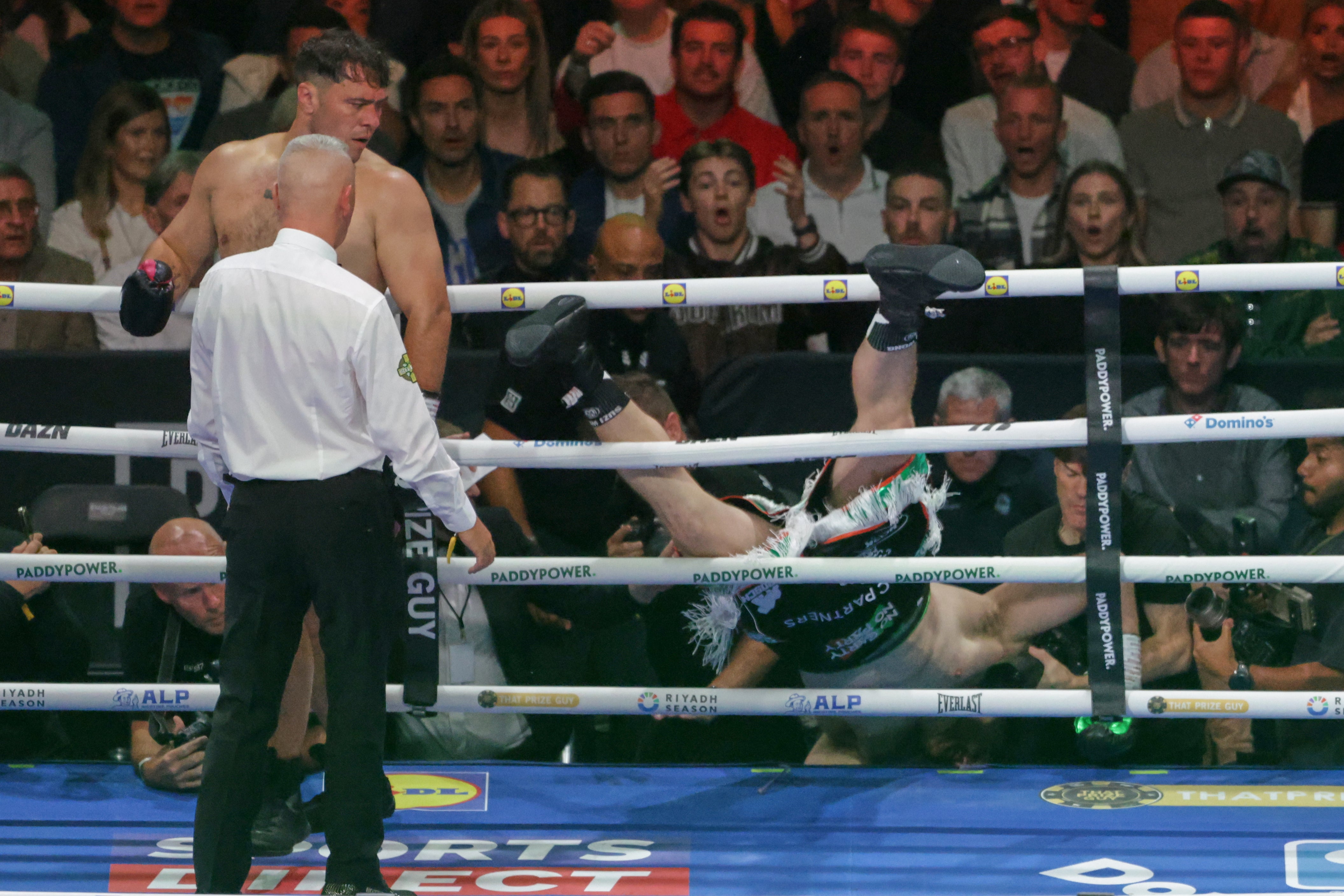 Carty tumbling out of the ring in round one