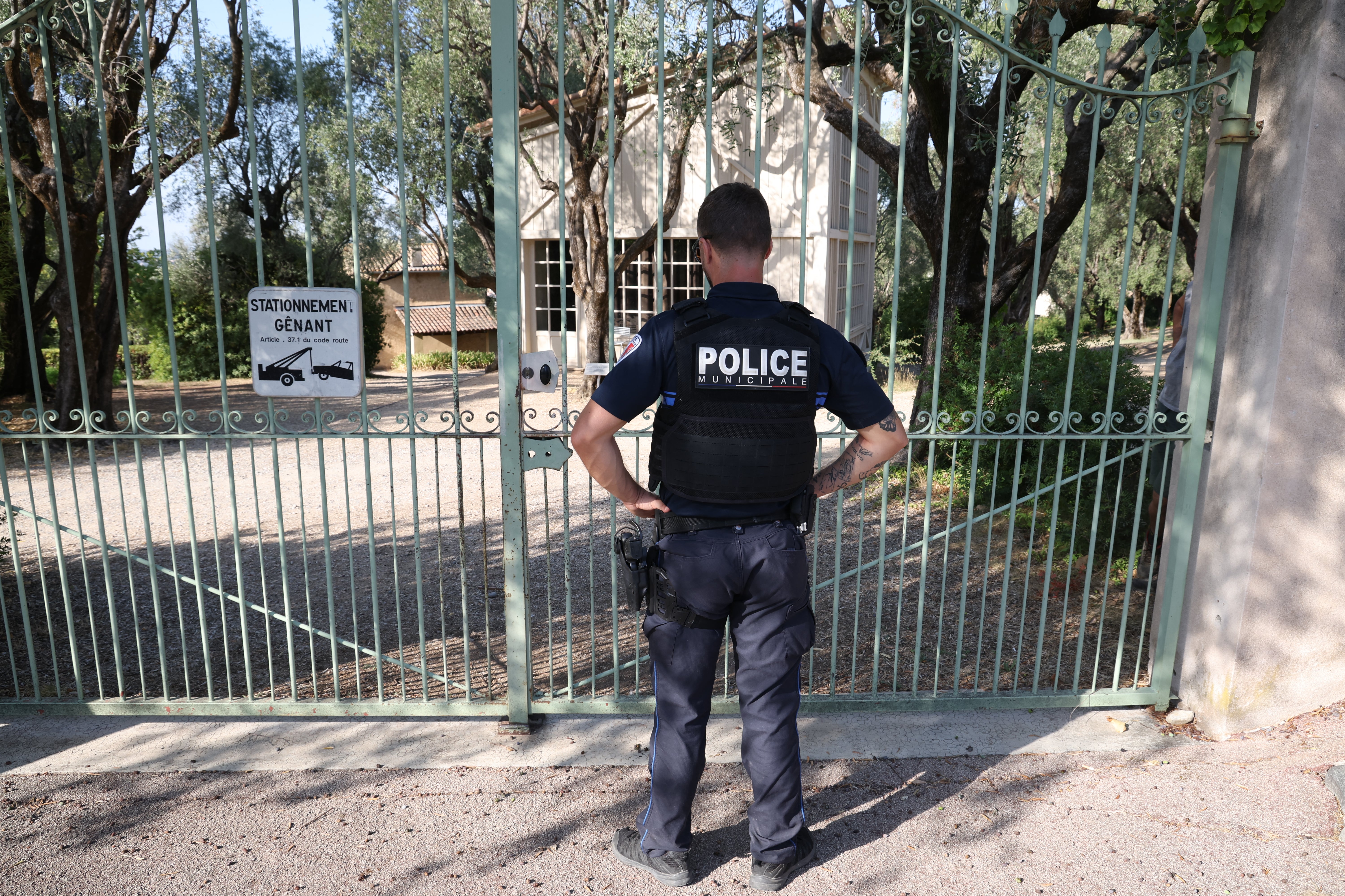A police officer stands in front of the entrance of the Musee Renoir after four paintings were stolen on Tuesday morning
