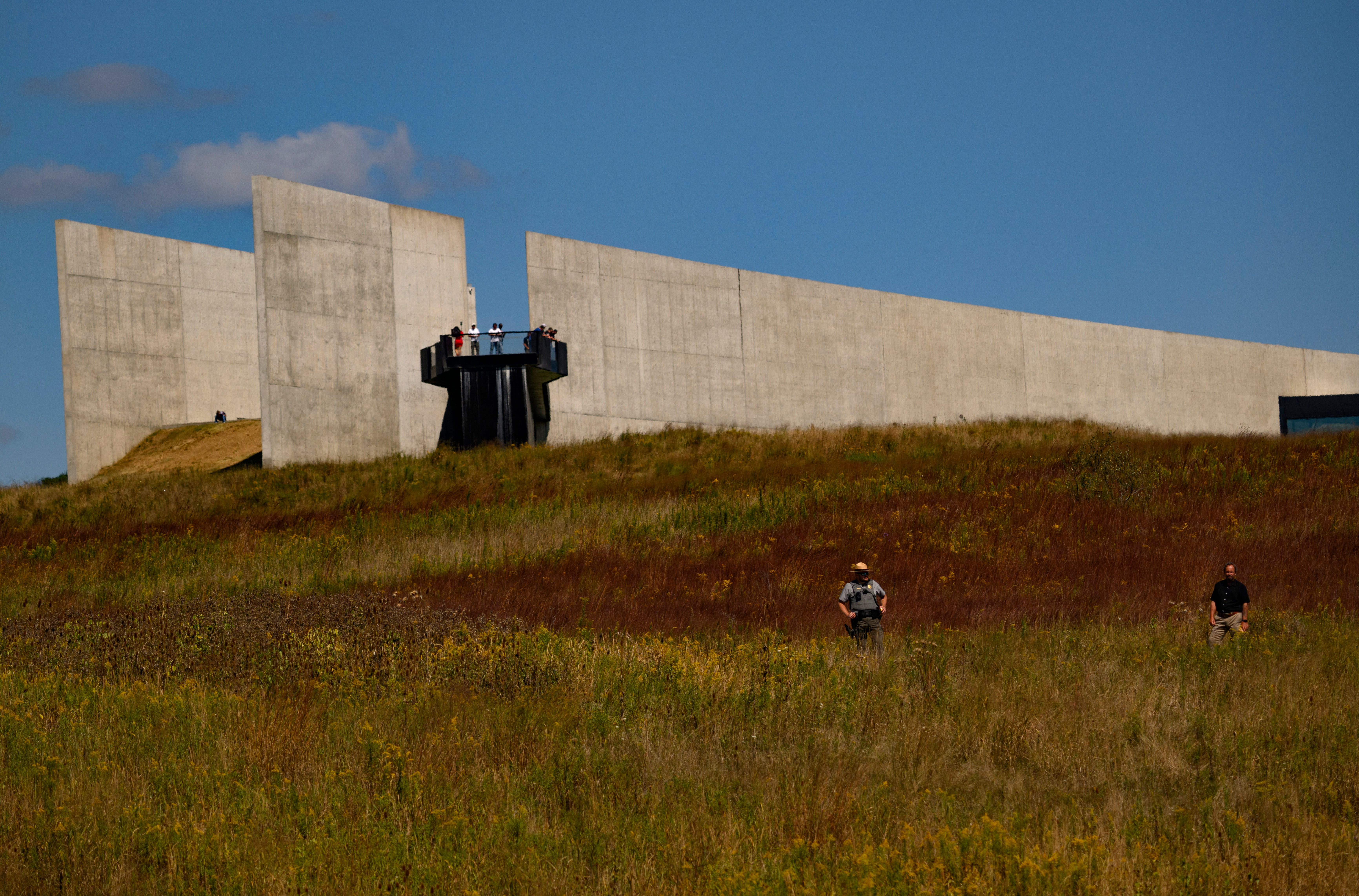 Visitors look over the crash site following the memorial ceremony at the Flight 93 National Memorial