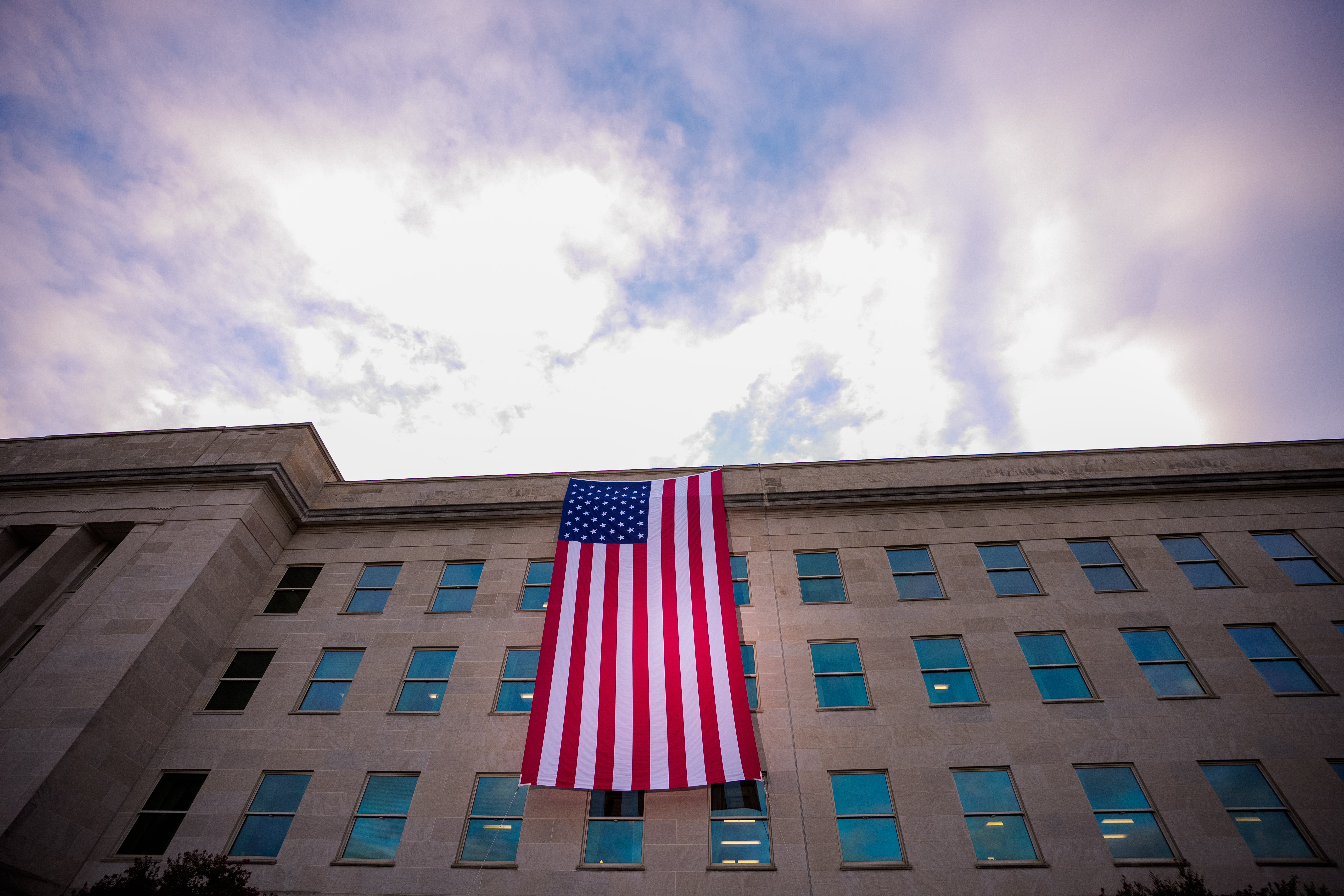 A large American flag after it is unfurled on the side of the Pentagon