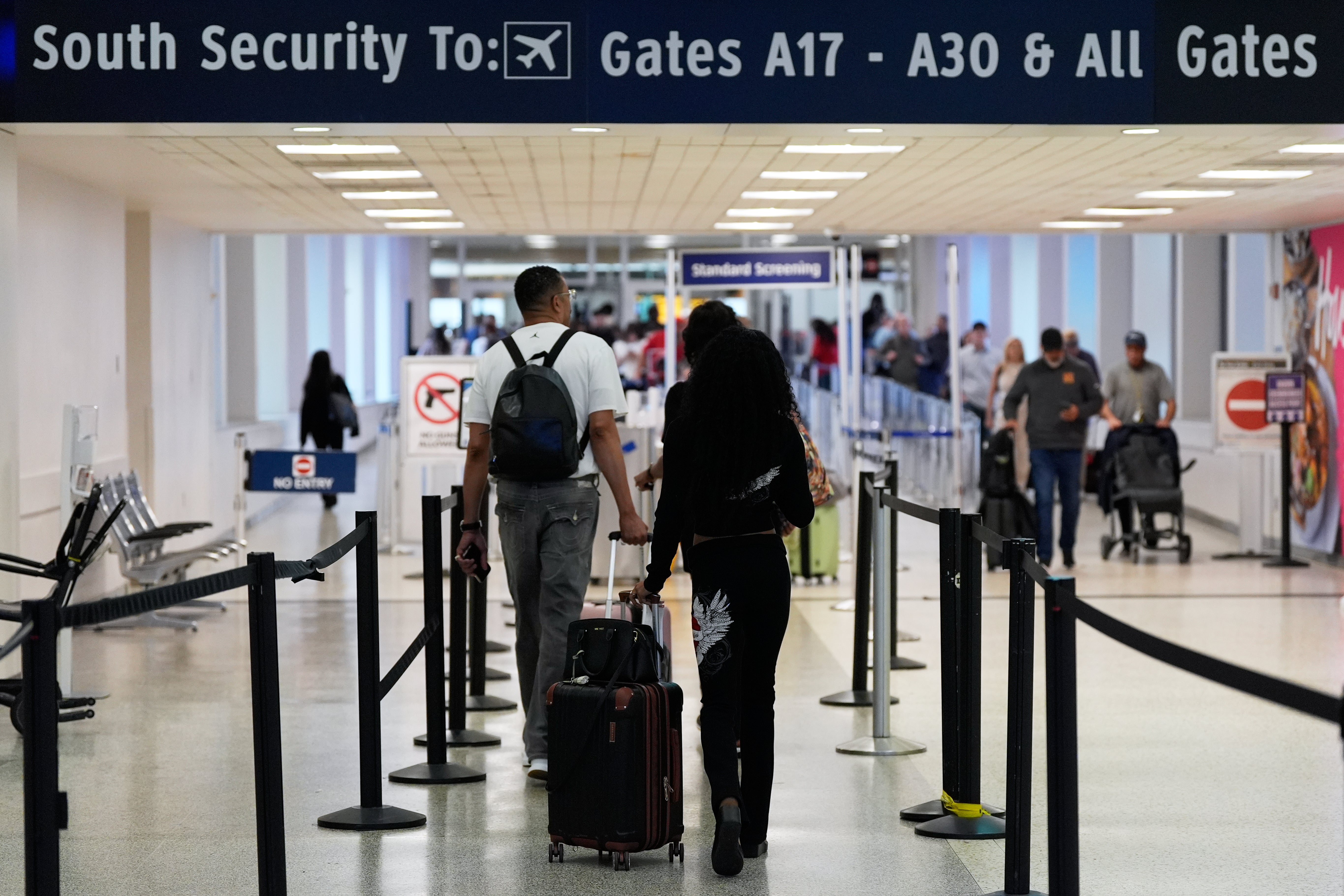 Travelers walk through TSA security lines at George Bush Intercontinental Airport