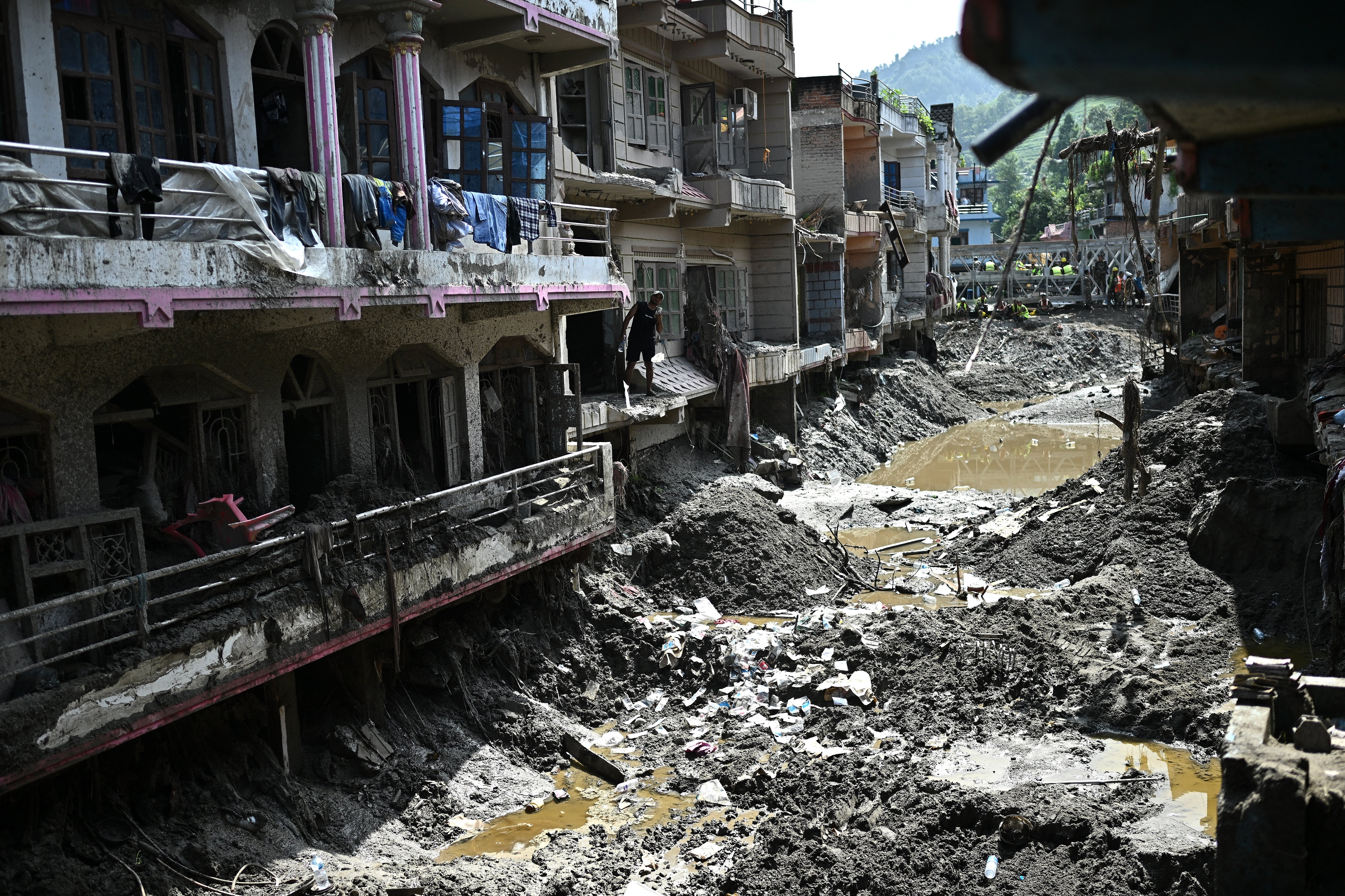A man looks at the remains of houses in the aftermath of flash floods at Devighat in Nepal's Nuwakot district on 8 September 2026
