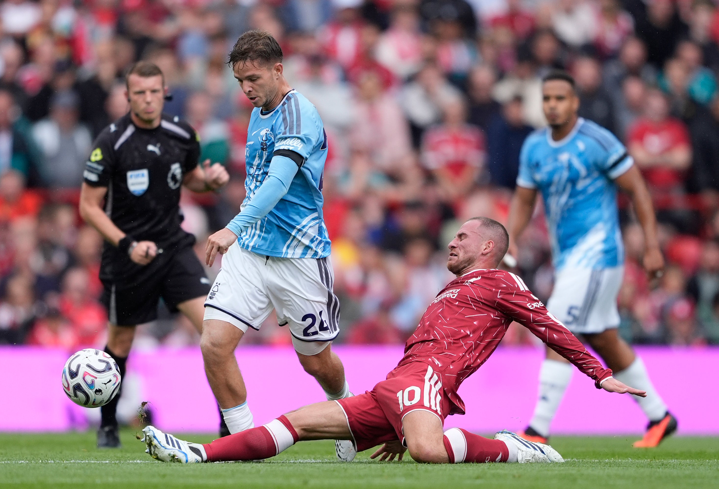 Alexis Mac Allister puts in a sliding tackle on Nottingham Forest midfielder James McAtee