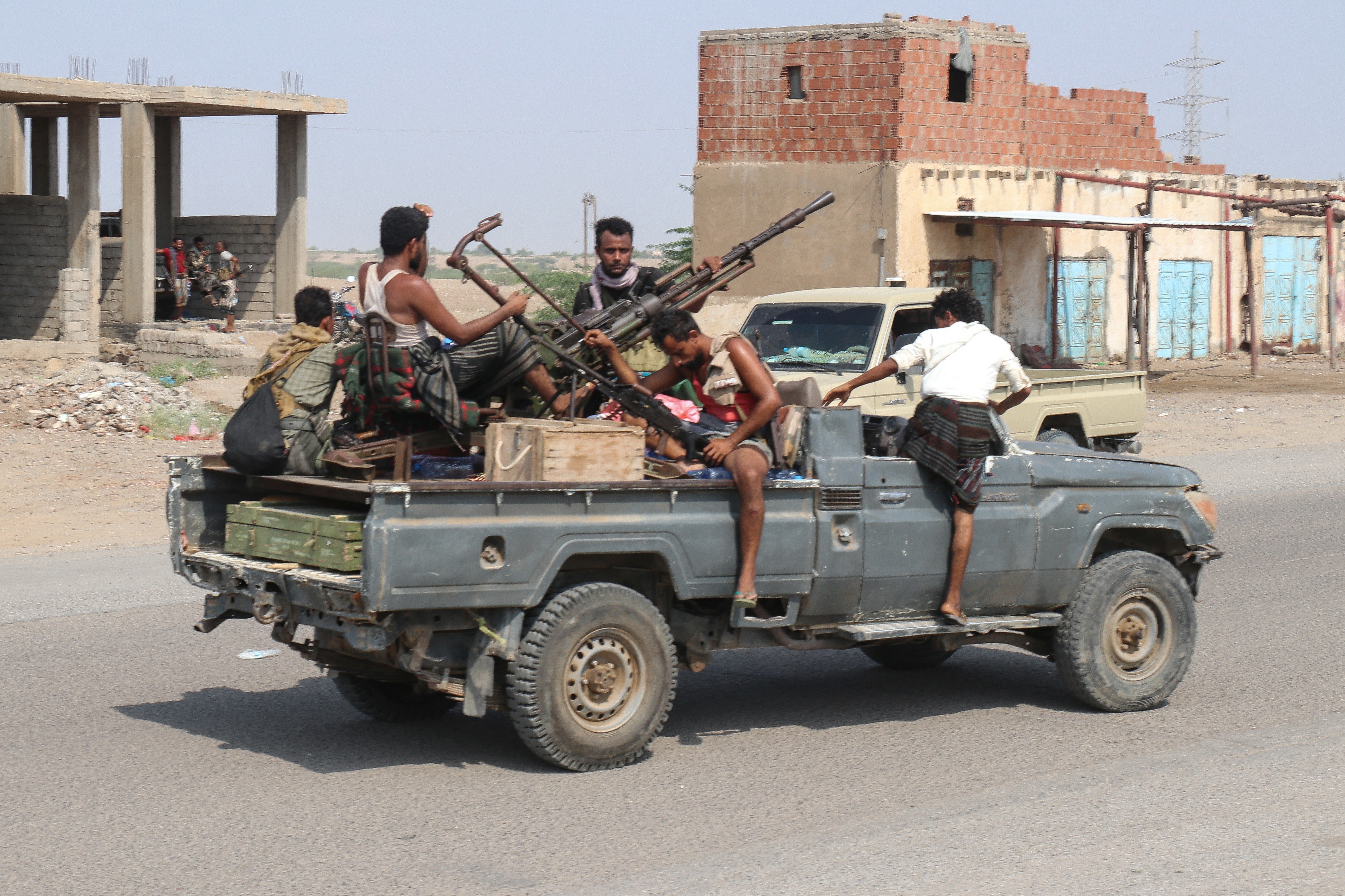 Forces loyal Yemen's Saudi-backed government ride in a pick-up truck in the Hays district, south of Hodeidah on September 5