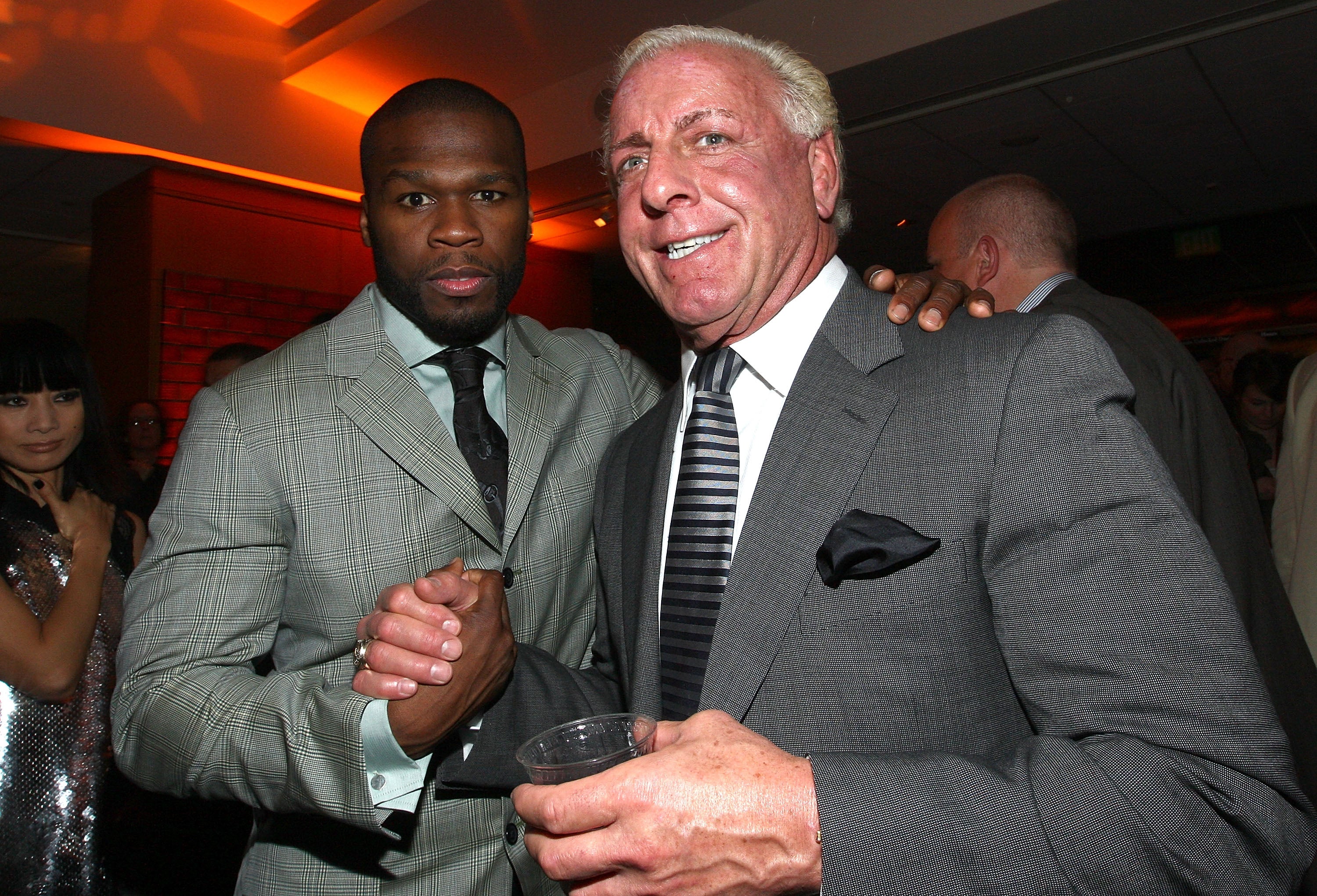 Ric Flair, seen here with rap superstar 50 Cent, claims he was tricked by an online talent agency and is now seeking at least $10 million