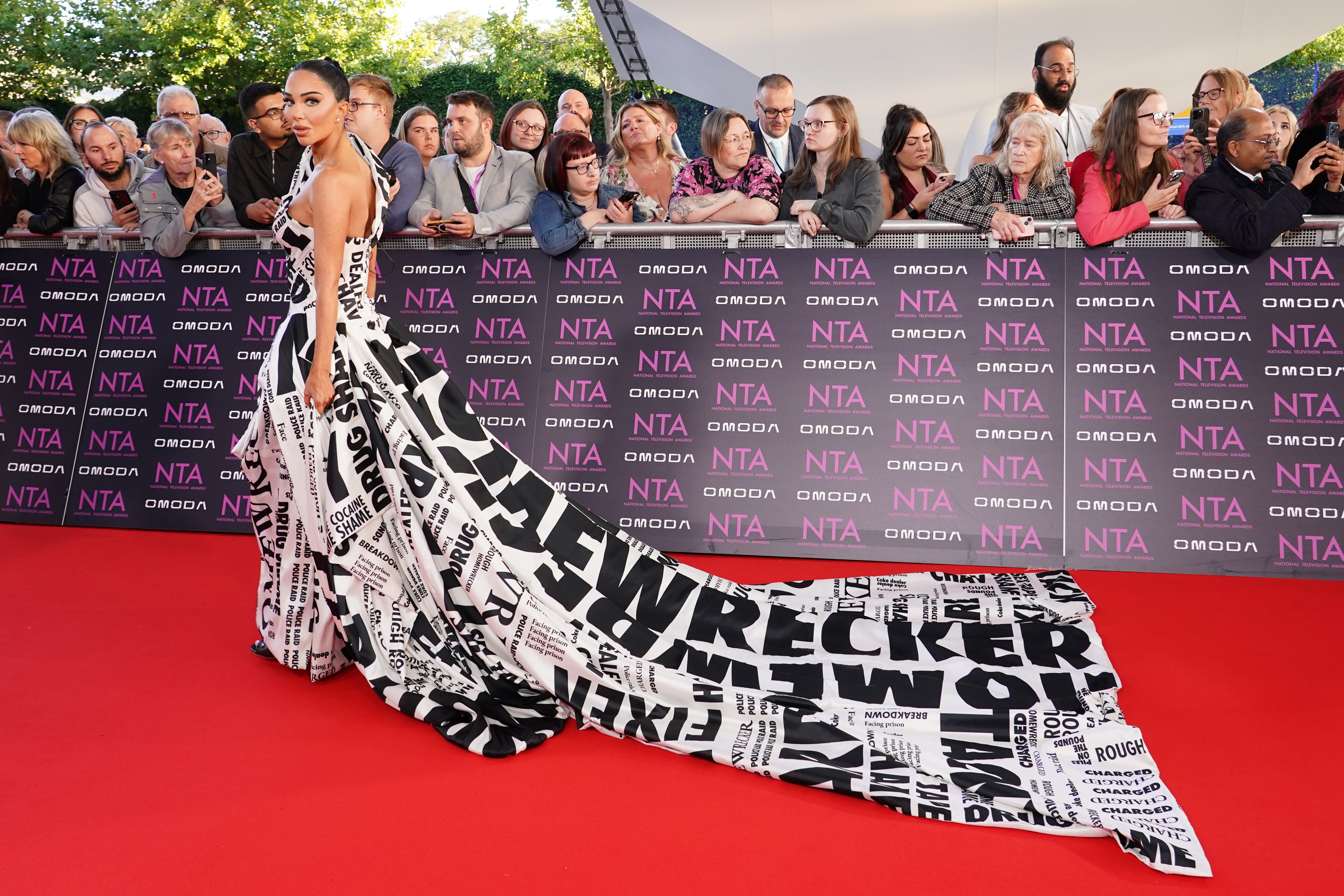 Tulisa shows off gown covered in headlines from drug sting scandal on NTA red carpet
