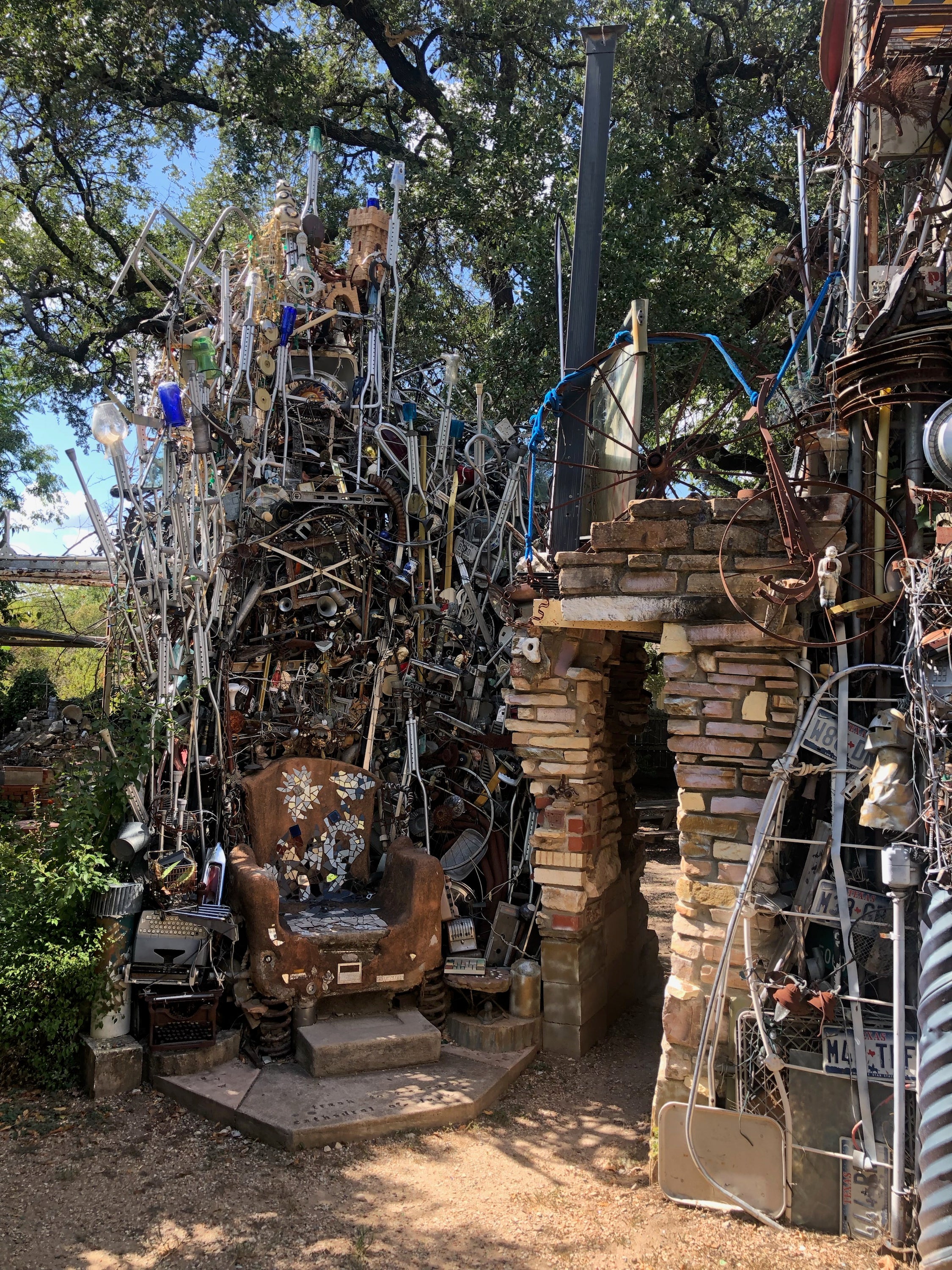 Visitors post pictures of themselves outside the installation, next to a 'Welcome To Fabulous Trash Vegas' sign or sitting on a throne made of upside-down crutches