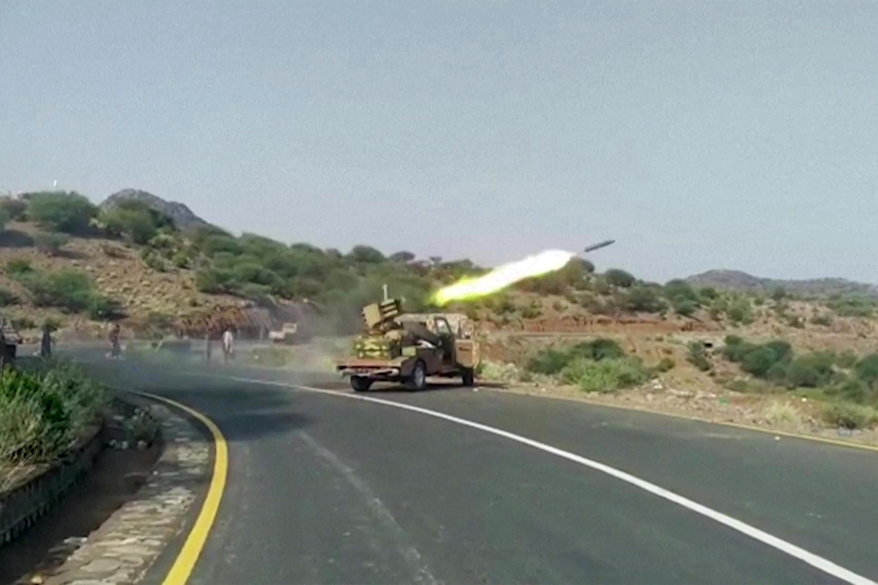 A rocket being fired from a vehicle-based launcher, as Yemeni government forces and National Resistance Forces fire at Houthi fighters on the Kadha front, west of the city of Taiz