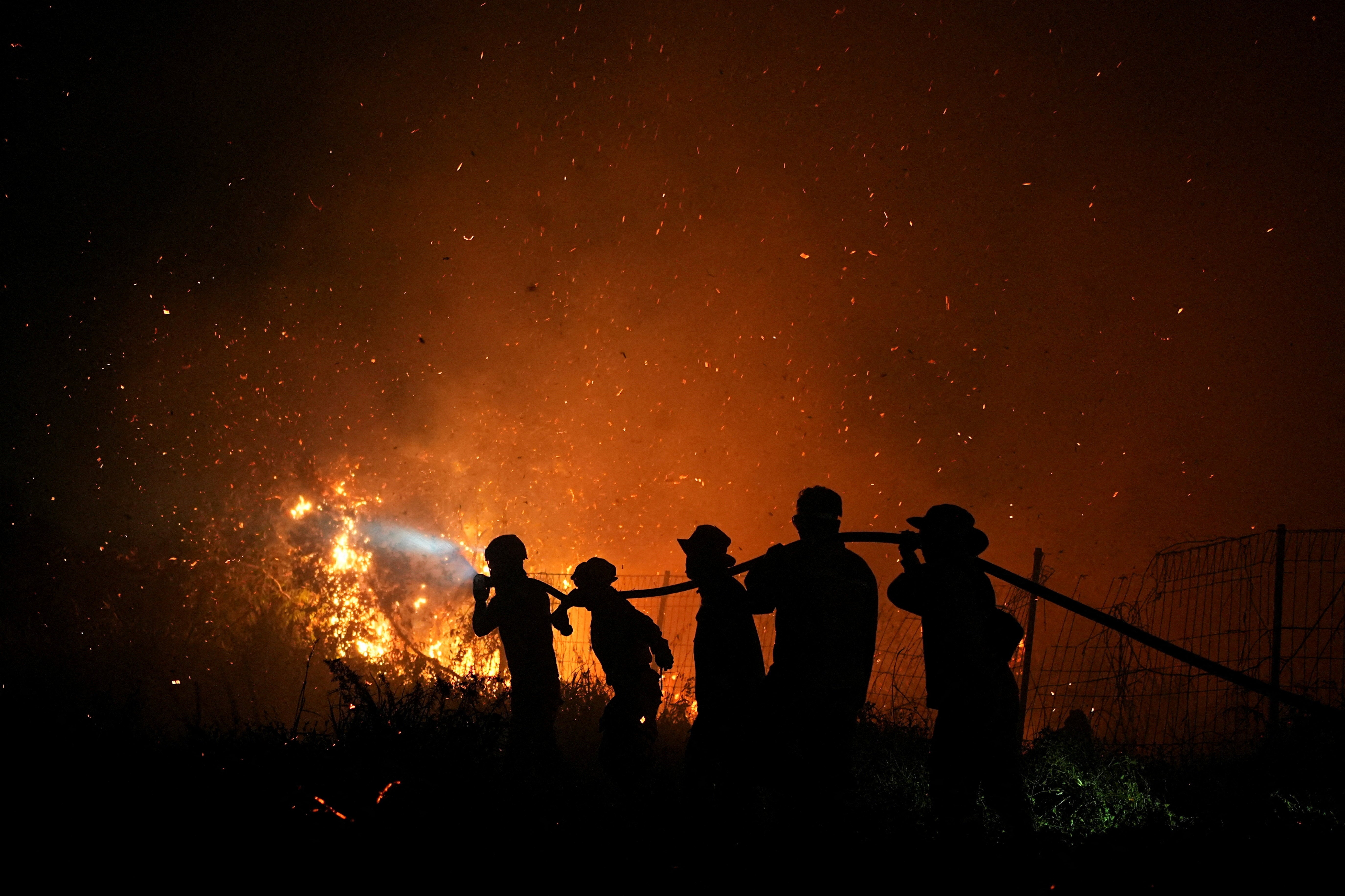Firefighters spray water in an attempt to extinguish a wildfire in Palembang, South Sumatra province, Indonesia, 8 September 2026 (Reuters)