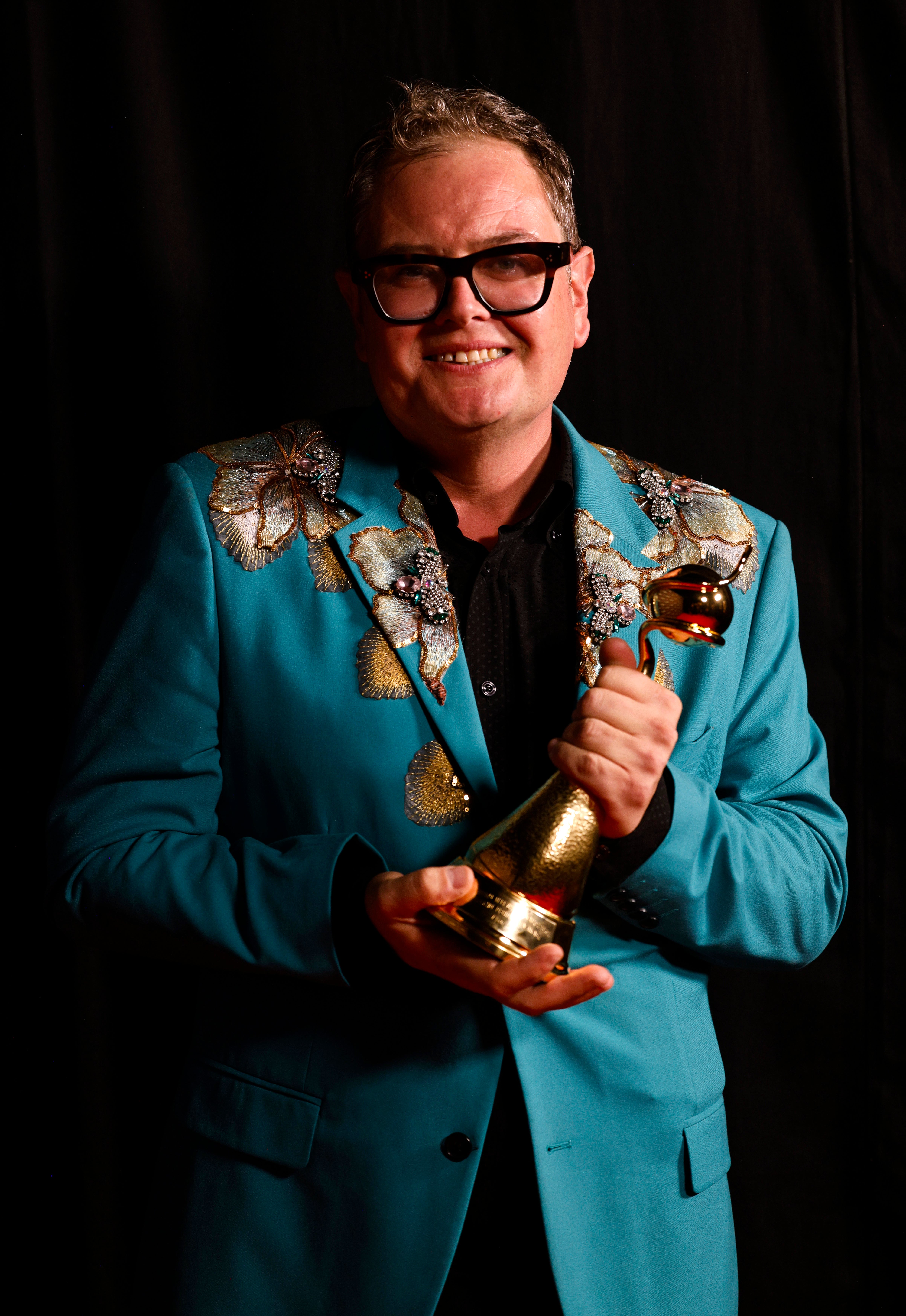 Alan Carr poses with his 'Special Recognition' award