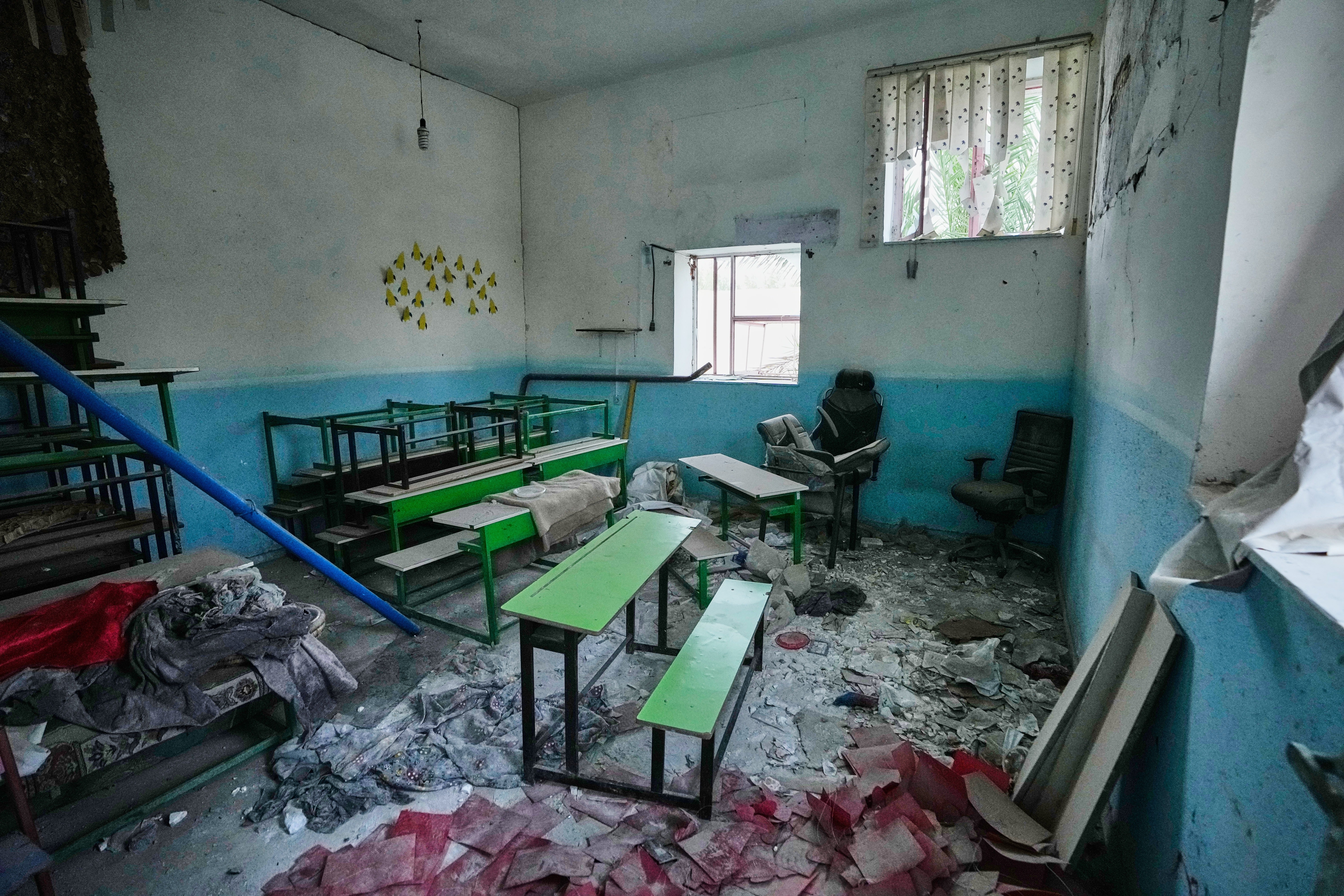 Classroom desks and chairs sit amid rubble at the Shajareh Tayyebeh school, damaged in a Feb. 28 U.S. airstrike in Minab, southern Iran