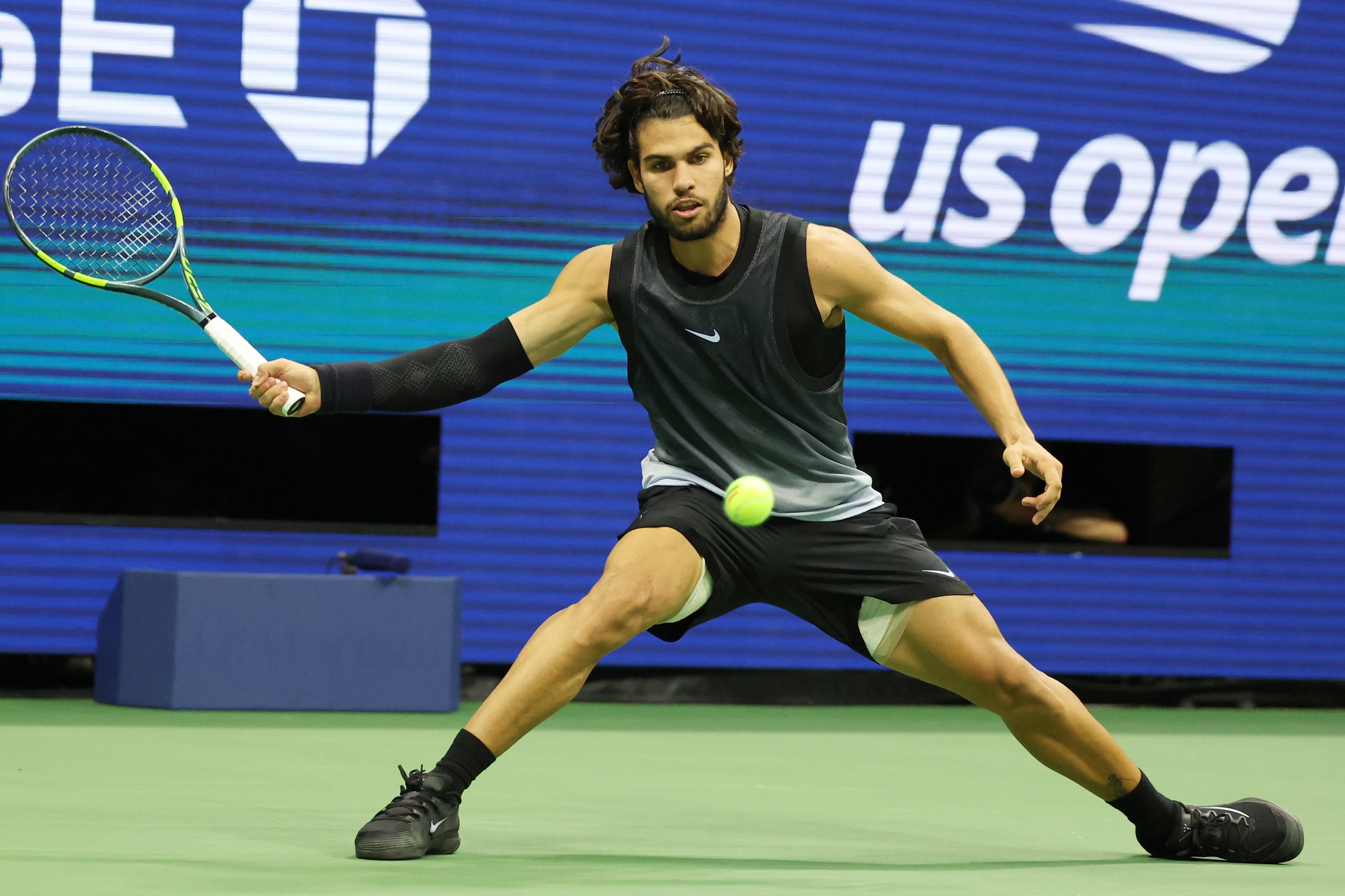 Carlos Alcaraz, of Spain, hits a return against Ben Shelton, of the United States