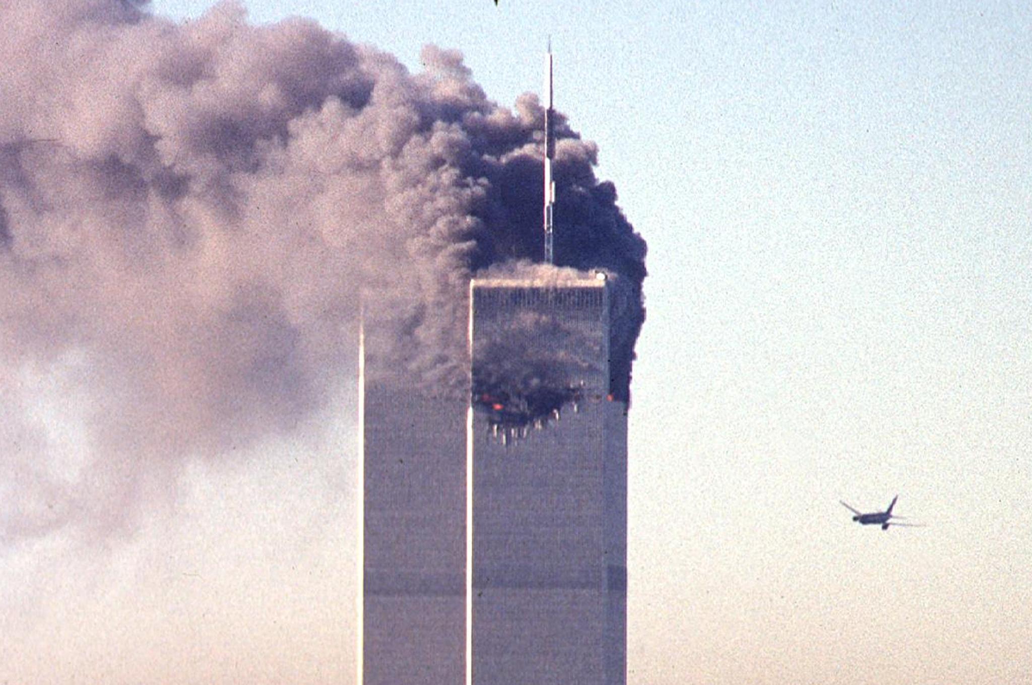 A hijacked commercial plane approaches the World Trade Center shortly before crashing into the landmark skyscraper 11 September 2001 in New York.