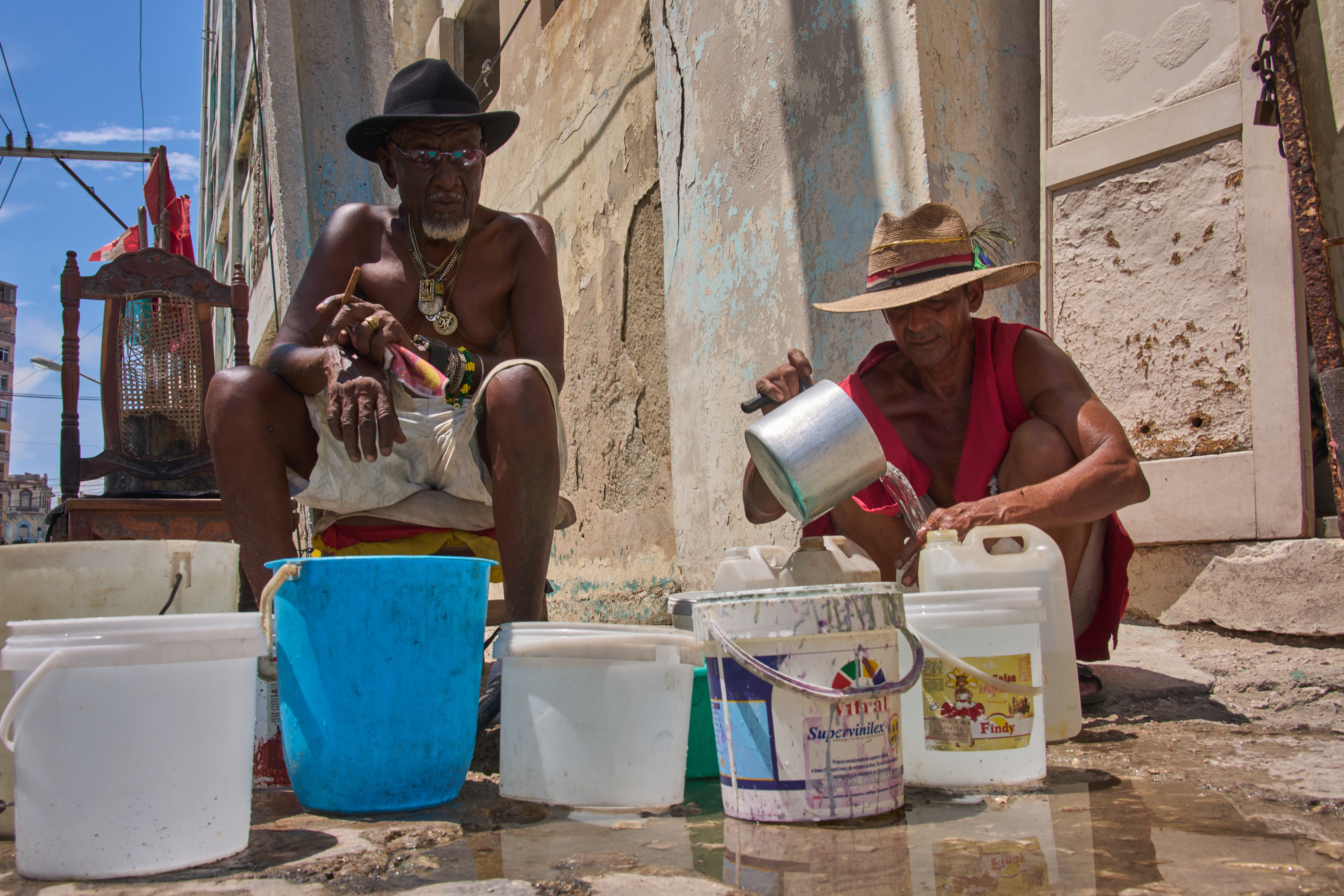 Oscar Joaquín López (left) and his housemate Wilfredo Cisneros Duarte collect water from a street pipe in Havana, Cuba on Sept. 7, 2026