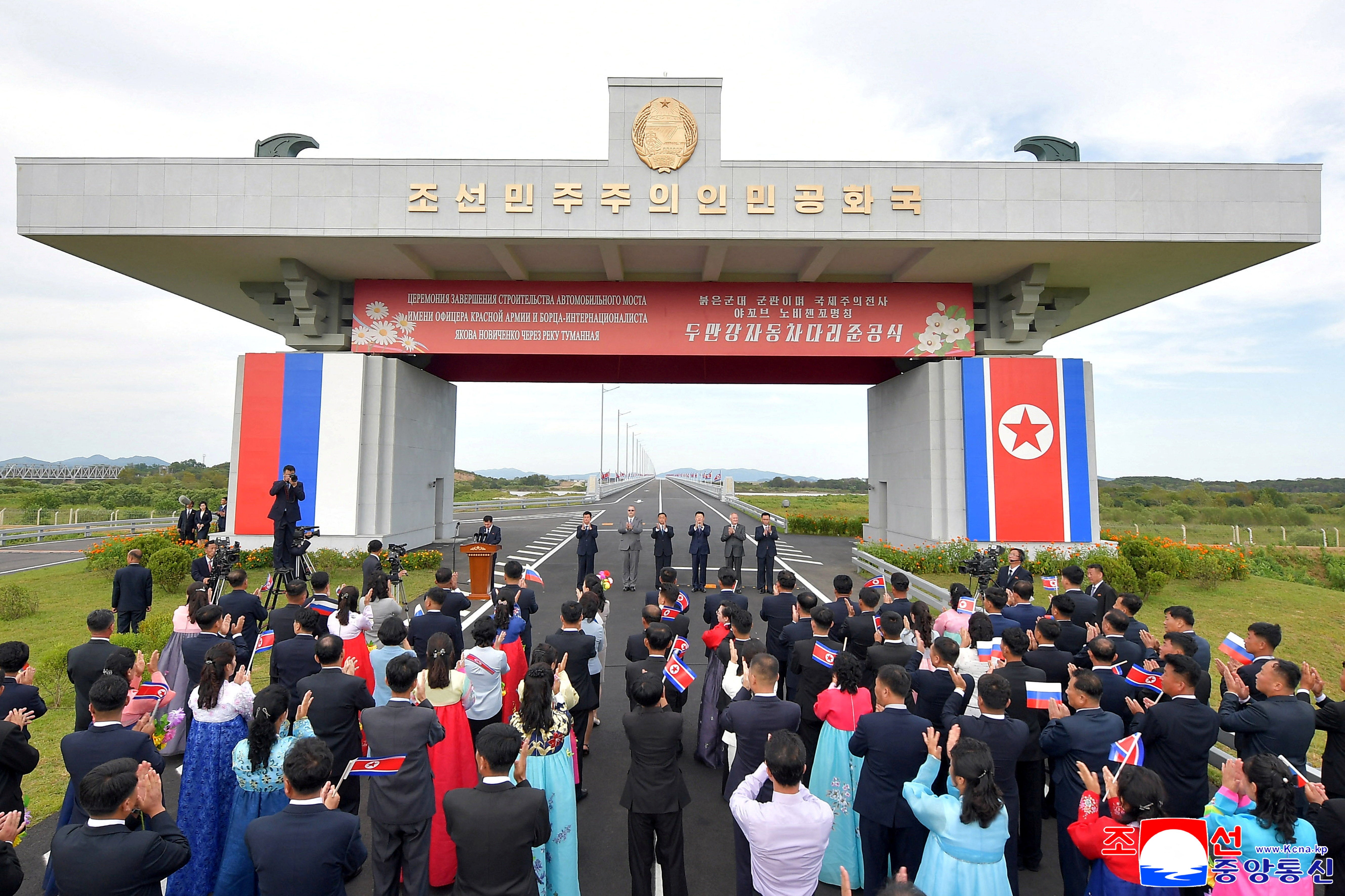 Attendees applaud as North Korea and Russia open their first road bridge across the Tumen river (Reuters)