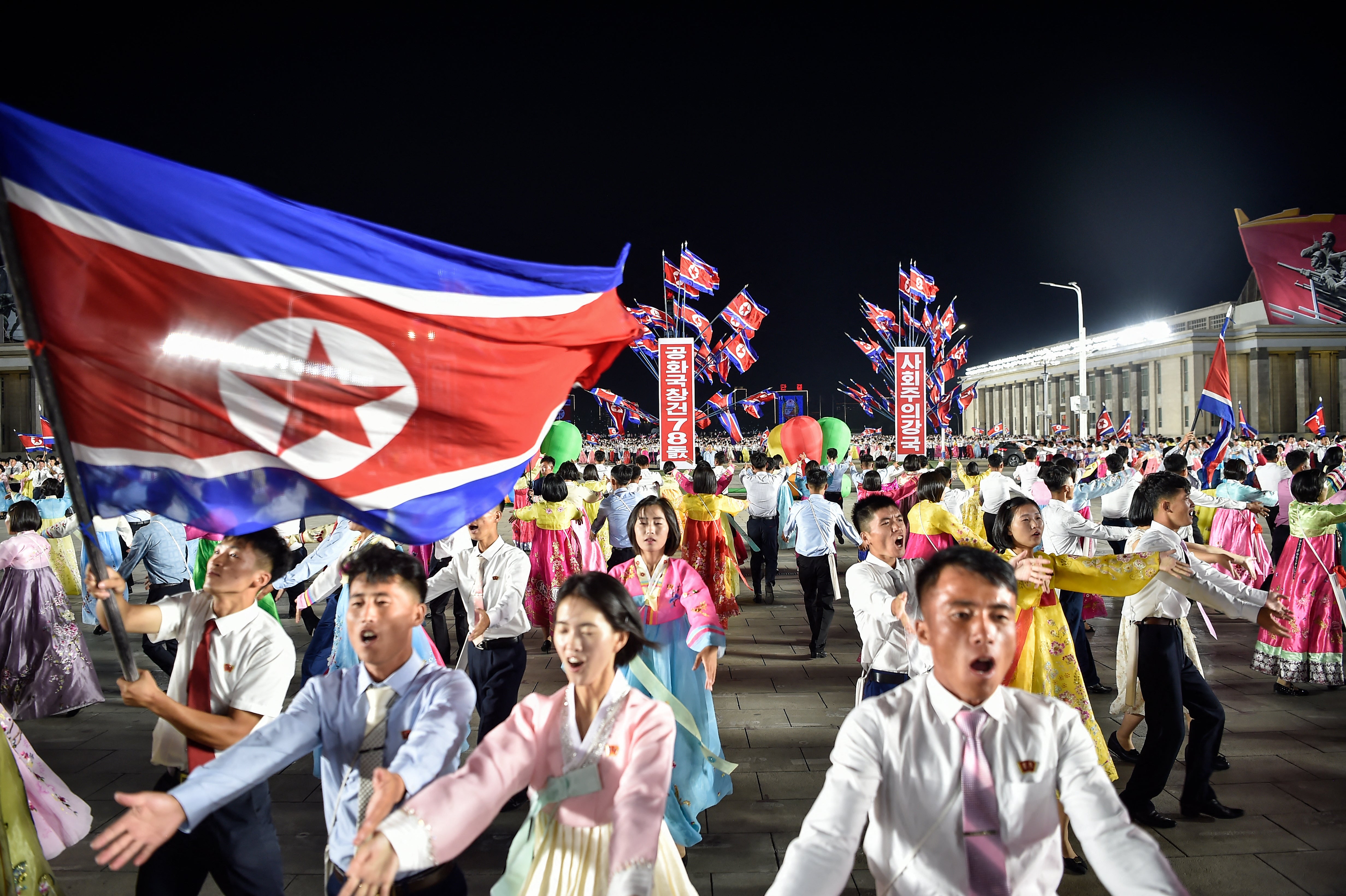 North Koreans dance during an evening gala to celebrate the 78th founding anniversary of their country (AFP/Getty)