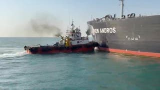 Water is sprayed on oil tanker New Andros, which according to port officials was struck by a drone in Iraqi territorial waters, at Sea, September 9,