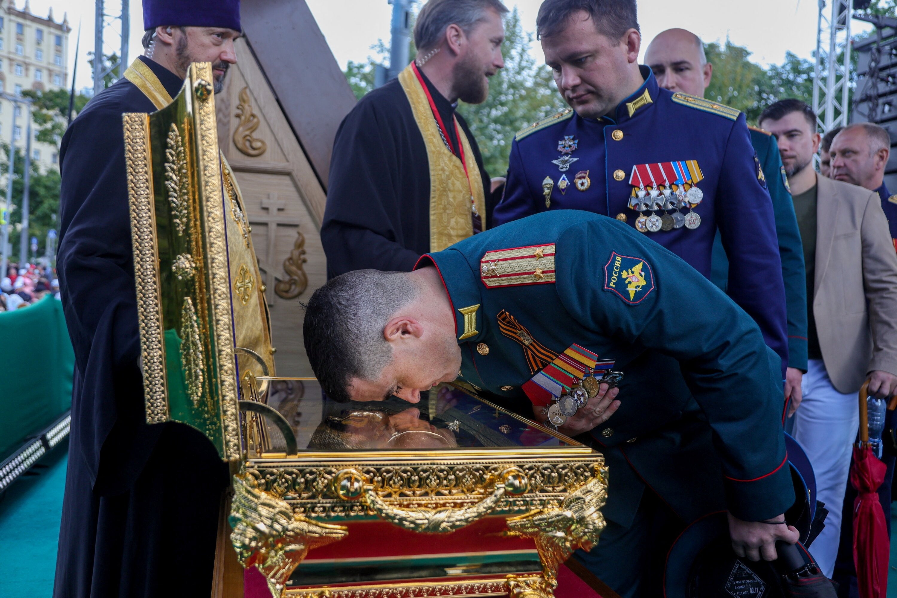 A Russian Army officer leans to a case with relics of a medieval Russian prince Dmitry Donskoy during a citywide procession marking the Feast of the Moscow Saints in Moscow, Russia, September 6, 2026
