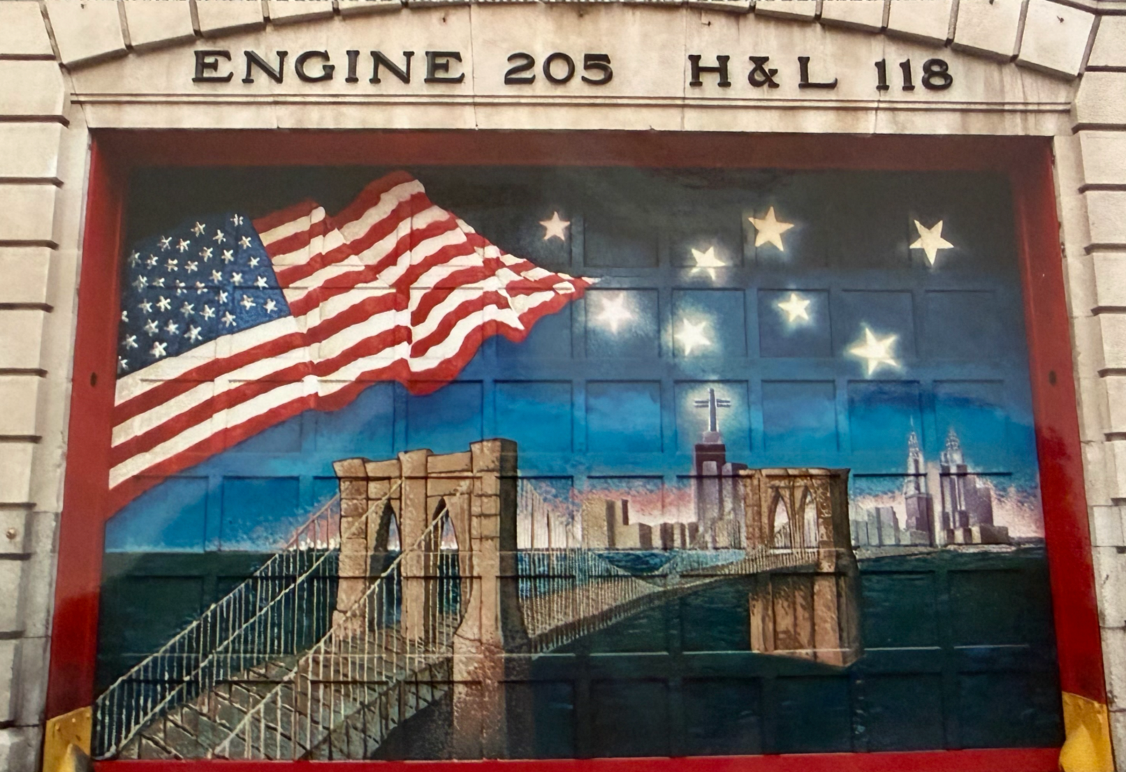 The mural of the Brooklyn Bridge and Ground Zero painted on to door of Engine 205's fire house. Eight firefighters died from the Brooklyn firehouse on September 11, 2001