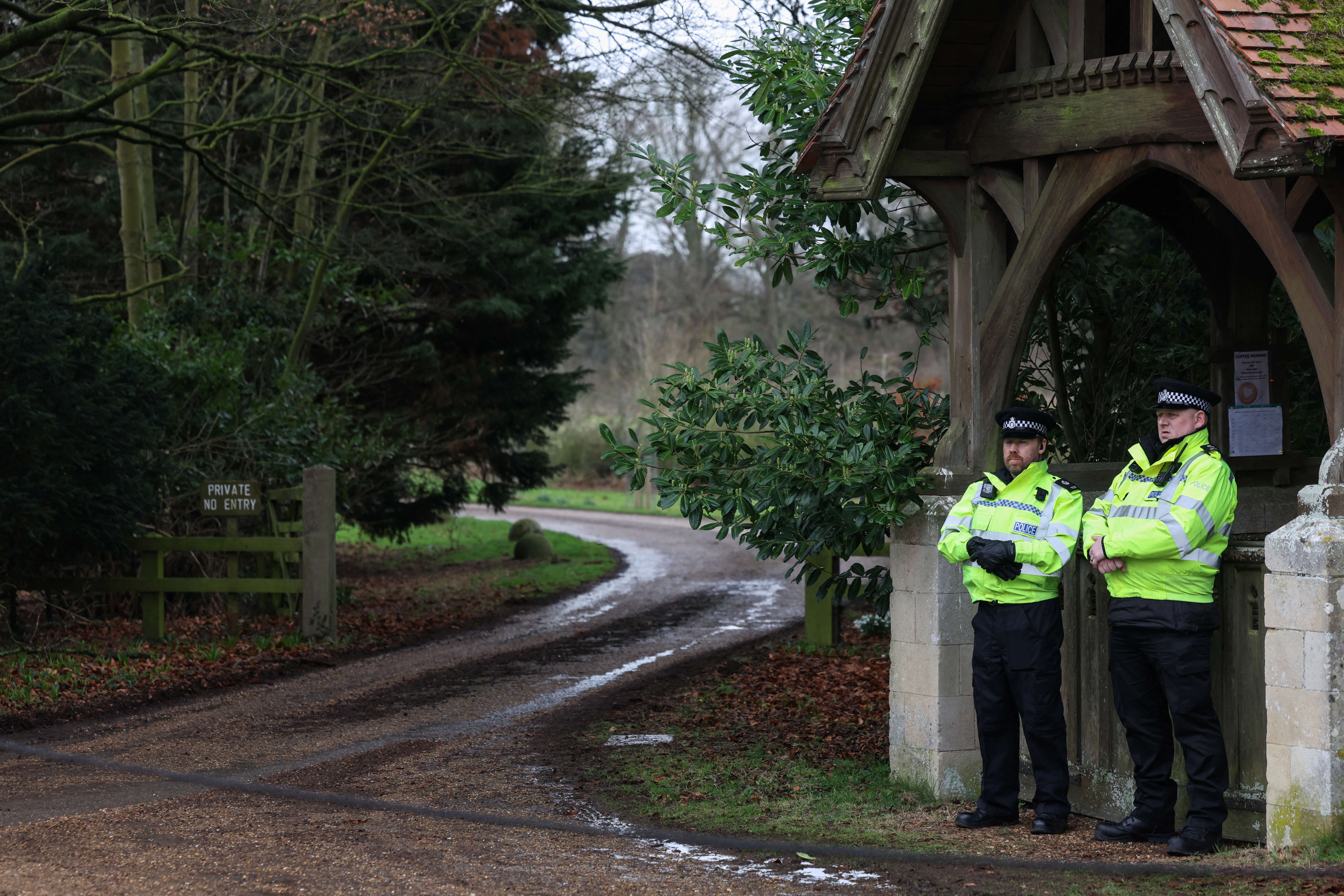 Police stand guard at an entrance to Wood Farm on the royal family's Sandringham Estate in Norfolk, eastern England on February 21, 2026, after Britain's former prince Andrew was arrested on February 19