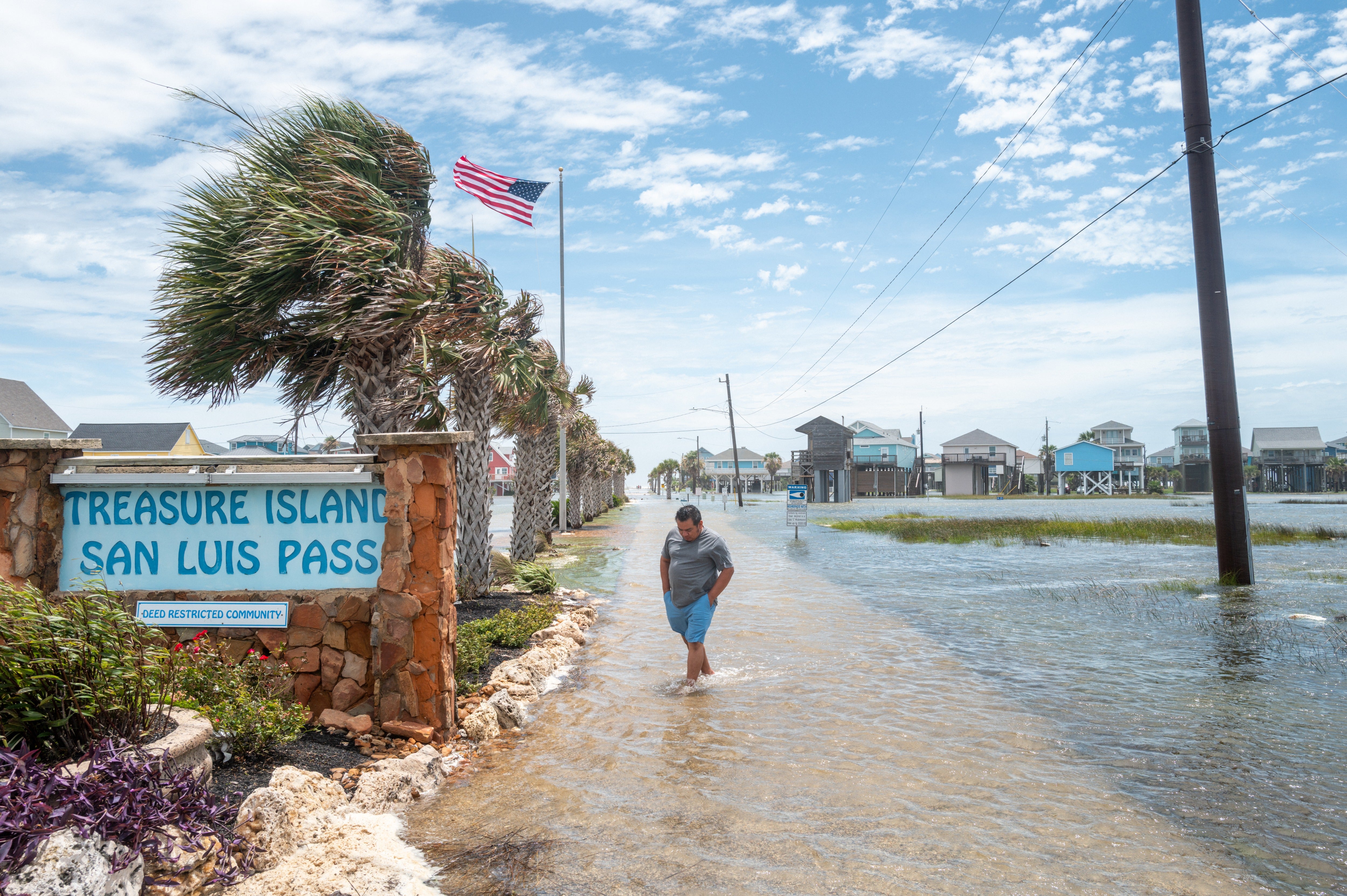 A person walks through a flooded neighborhood in Freeport, Texas, after Tropical Storm Arthur made landfall in June. Meteorologists say this year may see few, if any, Atlantic hurricanes