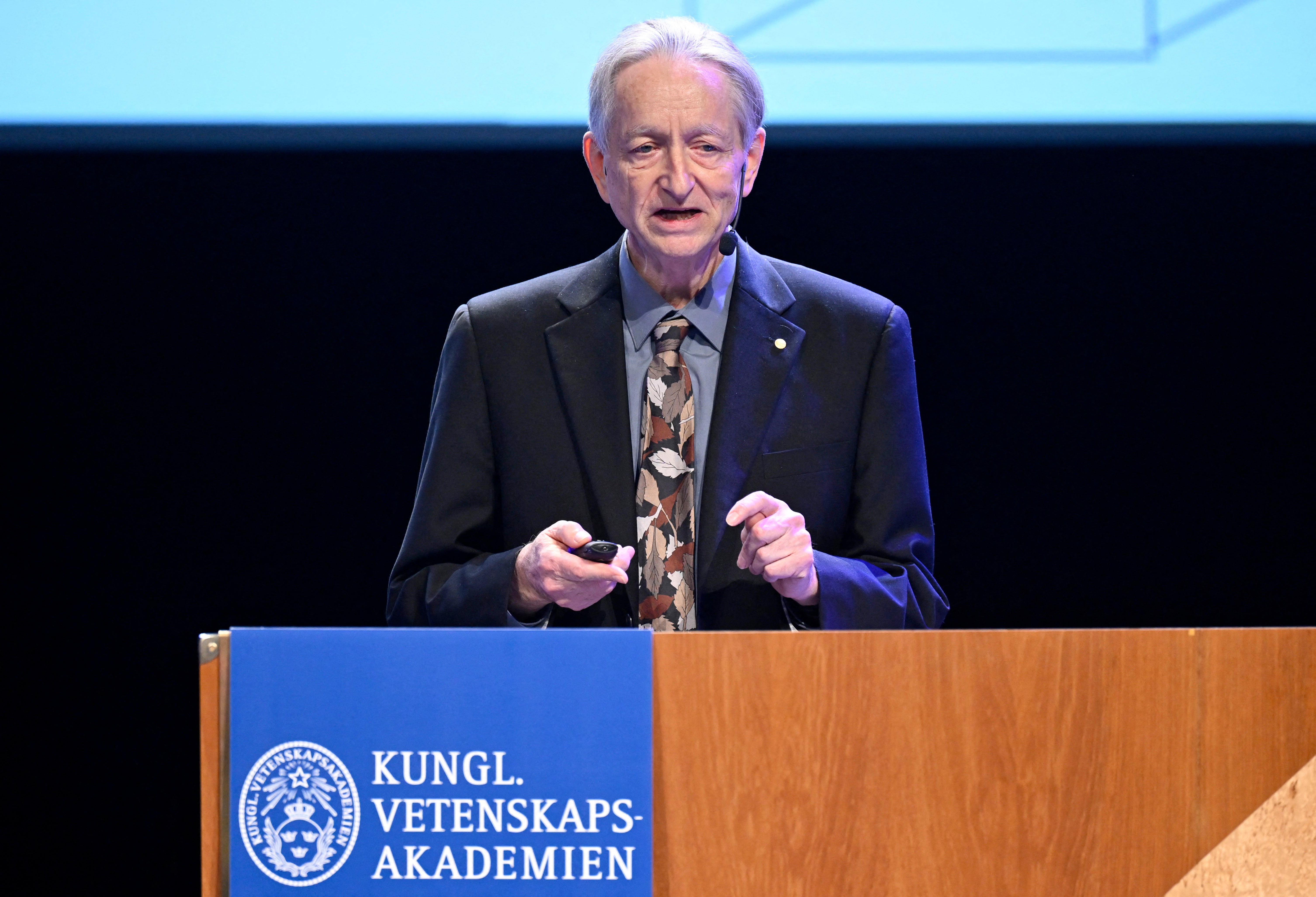Retired computer scientist and ‘godfather of AI’ Geoffrey Hinton, seen here delivering his Nobel Prize lecture in Aula Magna, Sweden, on December 8, 2024, is among the major tech figures who have warned of the potential threats posed by AI