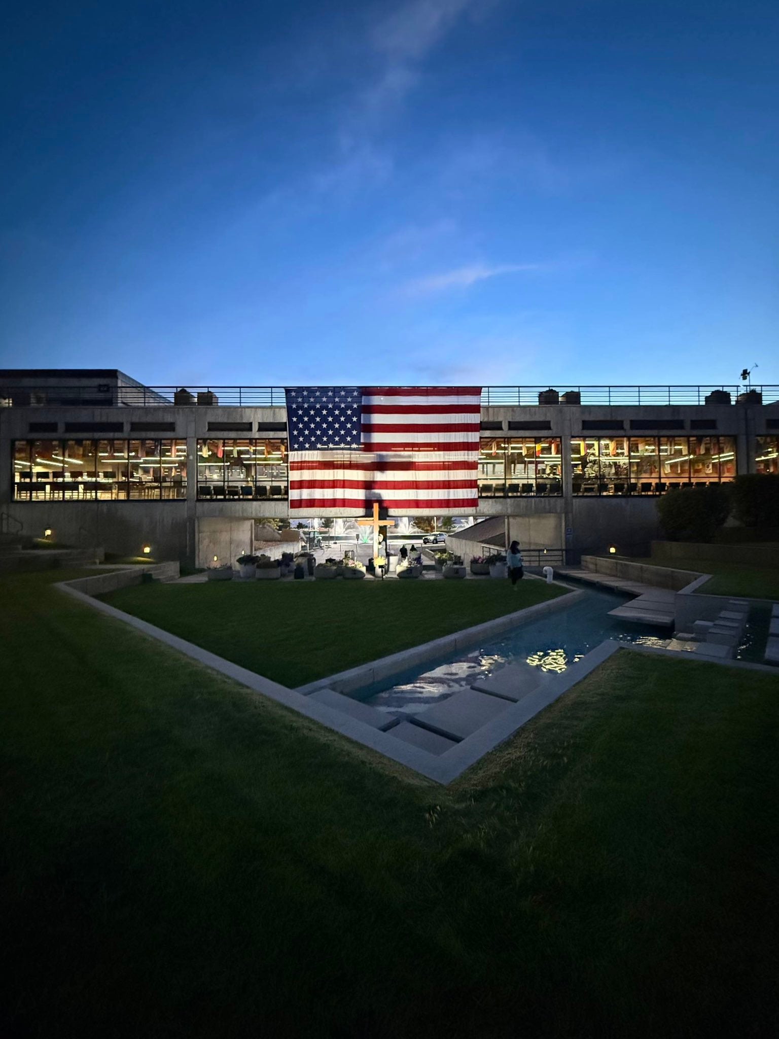 Turning Point shared a photo on social media Thursday of the site where Kirk was killed, resembling a shrine with an American flag and a wooden cross. The Independent understands that neither the cross nor the flag are permanent fixtures on campus
