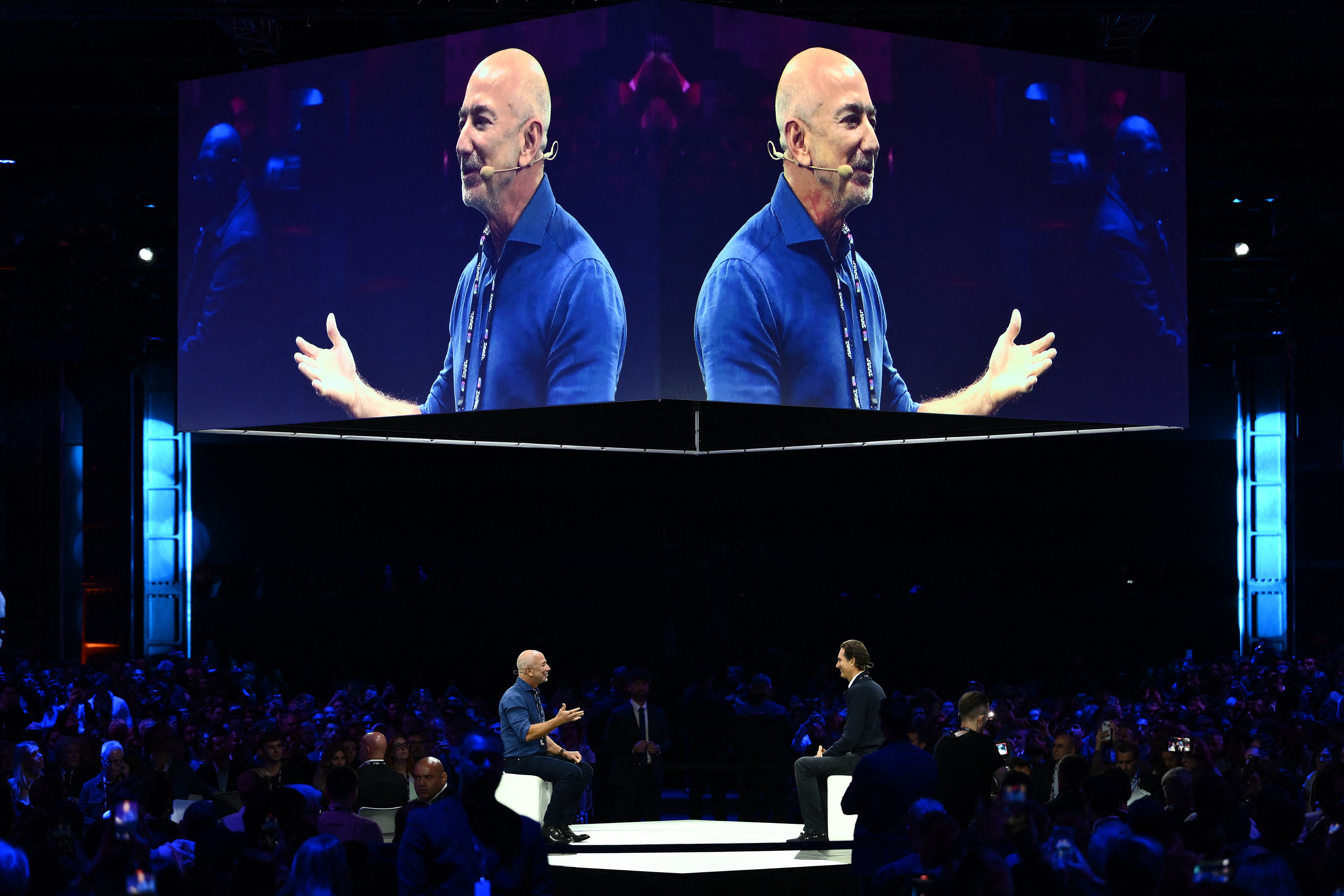 Jeff Bezos speaks with Stellantis chairman John Elkann at the Italian Tech Week 2025 in Turin in 2025. A Washington Post editorial that downplayed the potential threat to humanity posed by artificial intelligence didn’t mention that billionaire owner Bezos recently co-founded an AI company