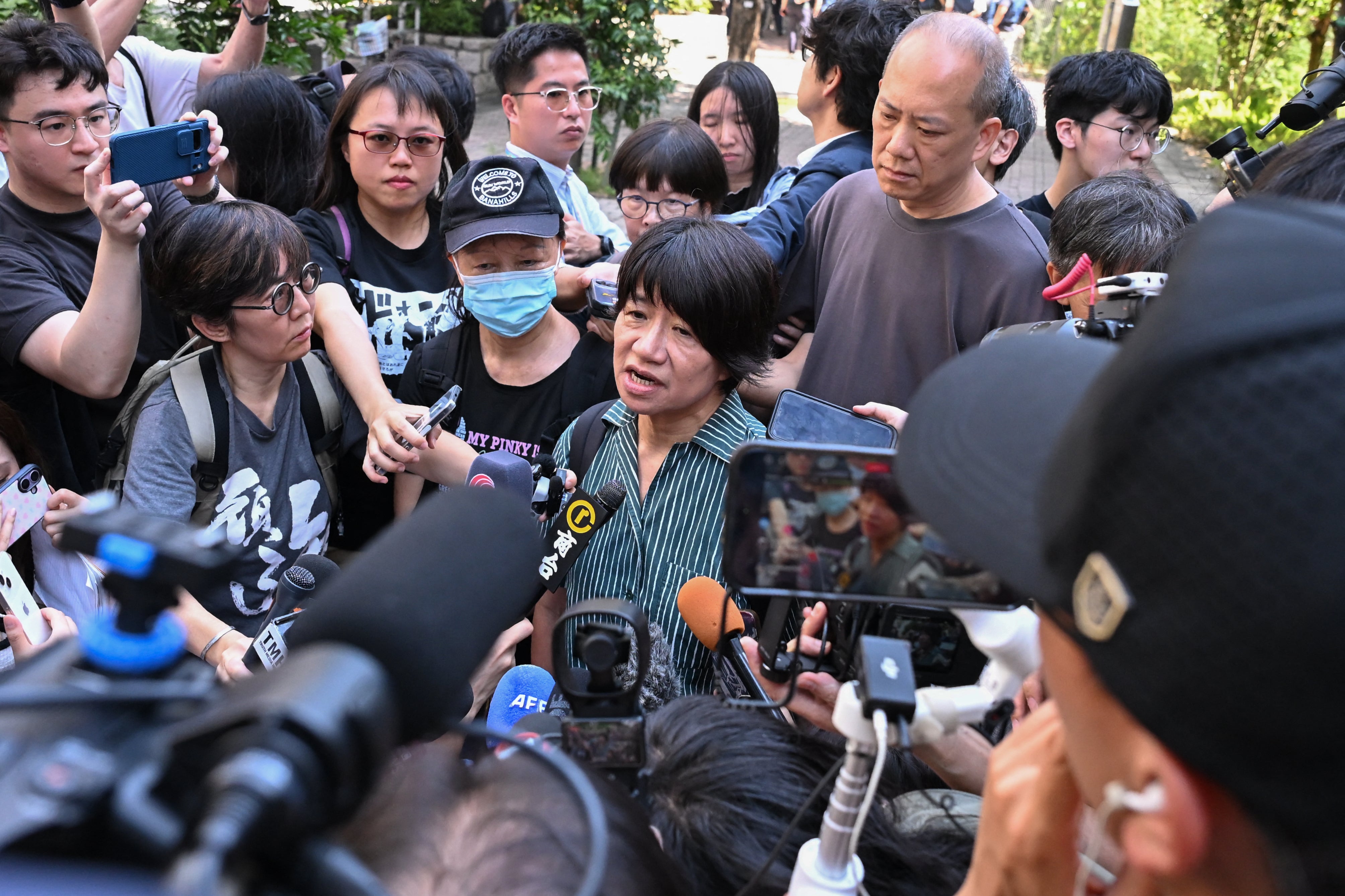 Elizabeth Tang Yin-ngor (C), wife of former union leader Lee Cheuk-yan, and Medina Chow Lau Wah-chun (L wearing a mask), Chow Hang-tung's mother, speak to the media after leaving the West Kowloon Magistrates' Courts following the sentencing in the national security trial of the pro-democracy activists, in Hong Kong on September 11, 2026 (AFP/Getty)