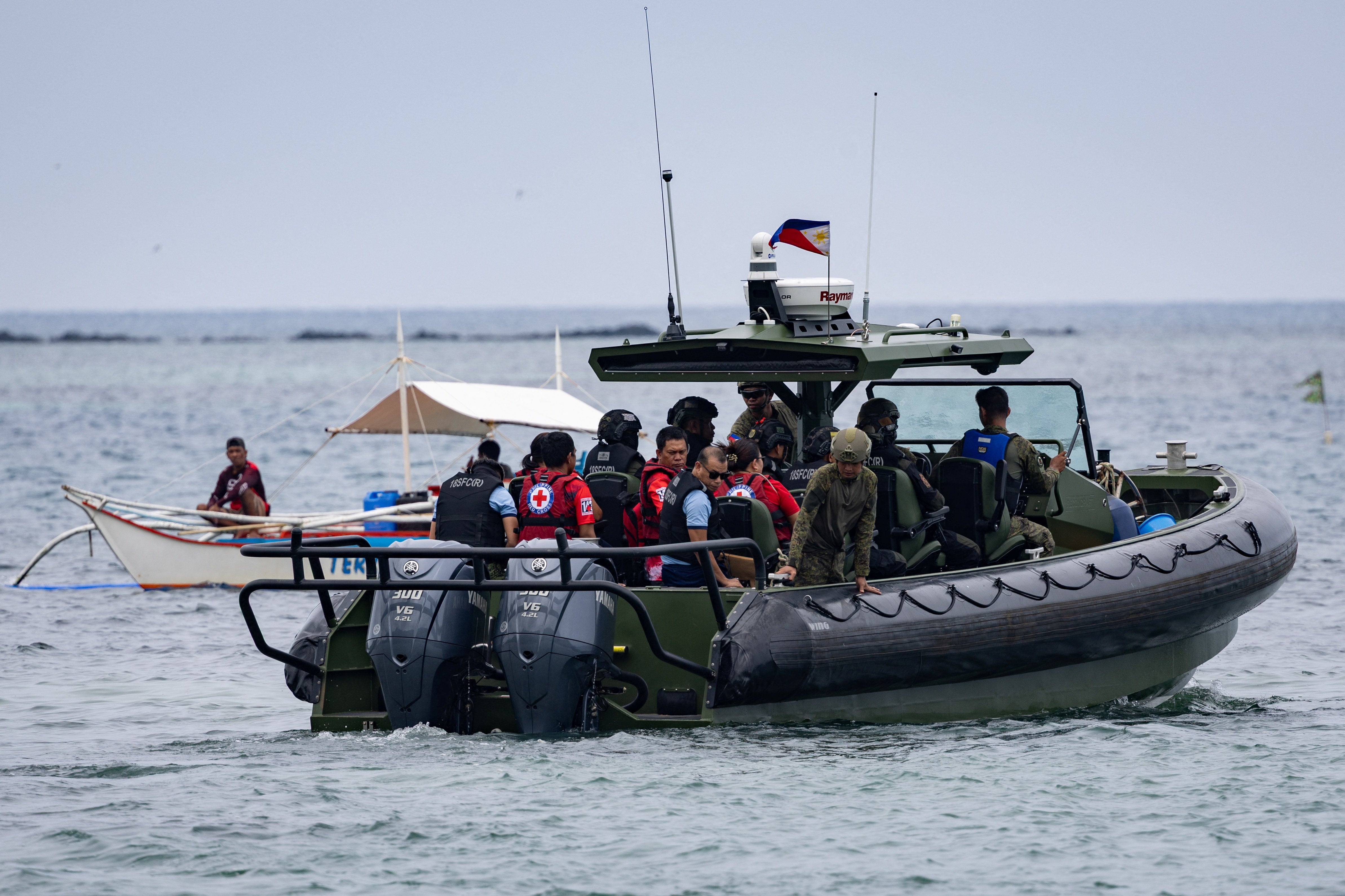 Authorities and responders board a vessel to assist ongoing search and rescue operations involving the MV June Aster ferry, which caught fire off the coast of Palawan, Philippines, 11 September 2026 (Reuters)